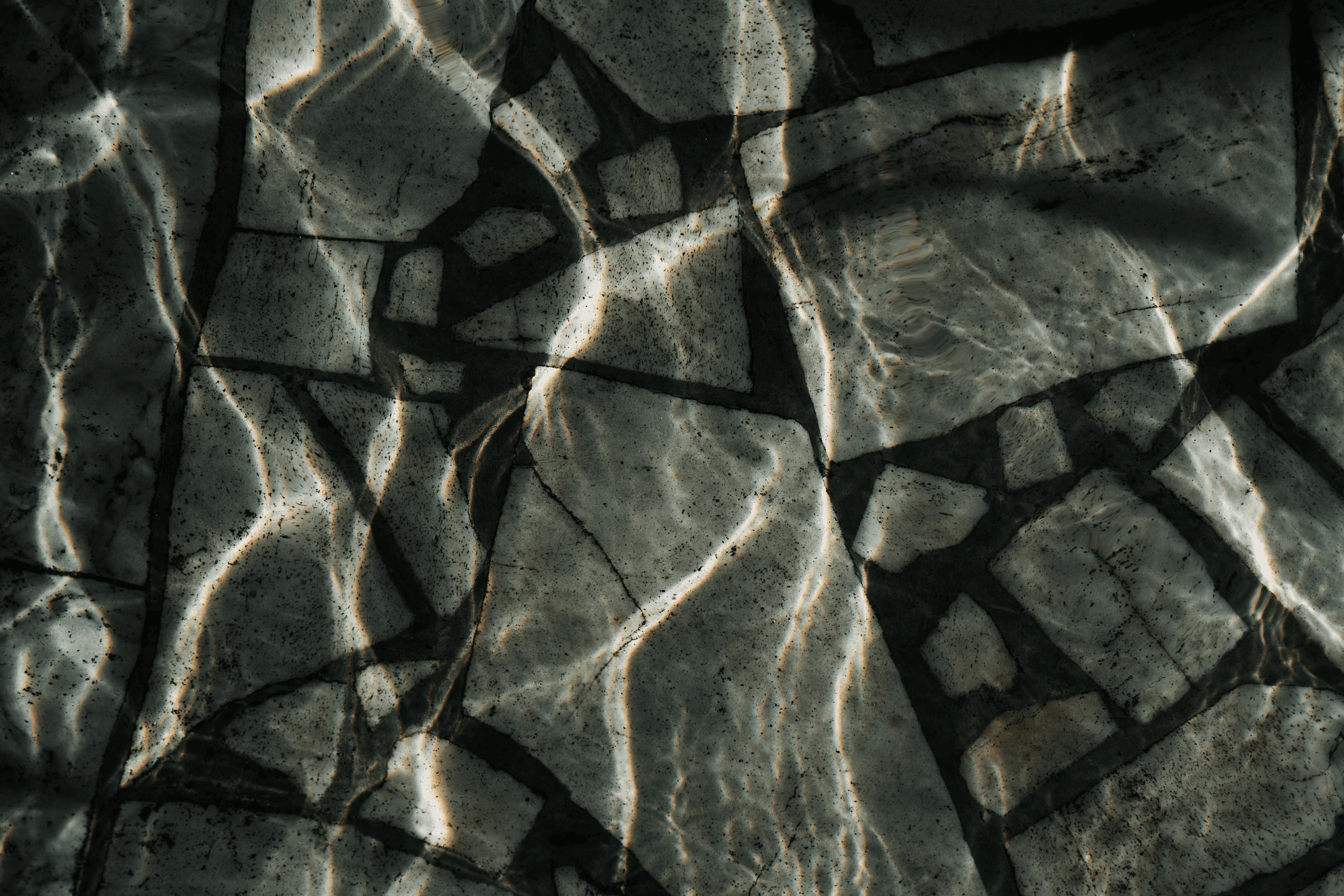 Abstract dark rock texture with light reflections
