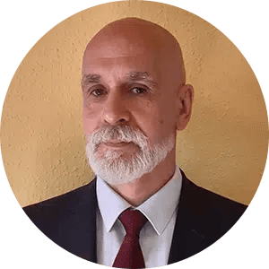 A suited man portrait against a warm background