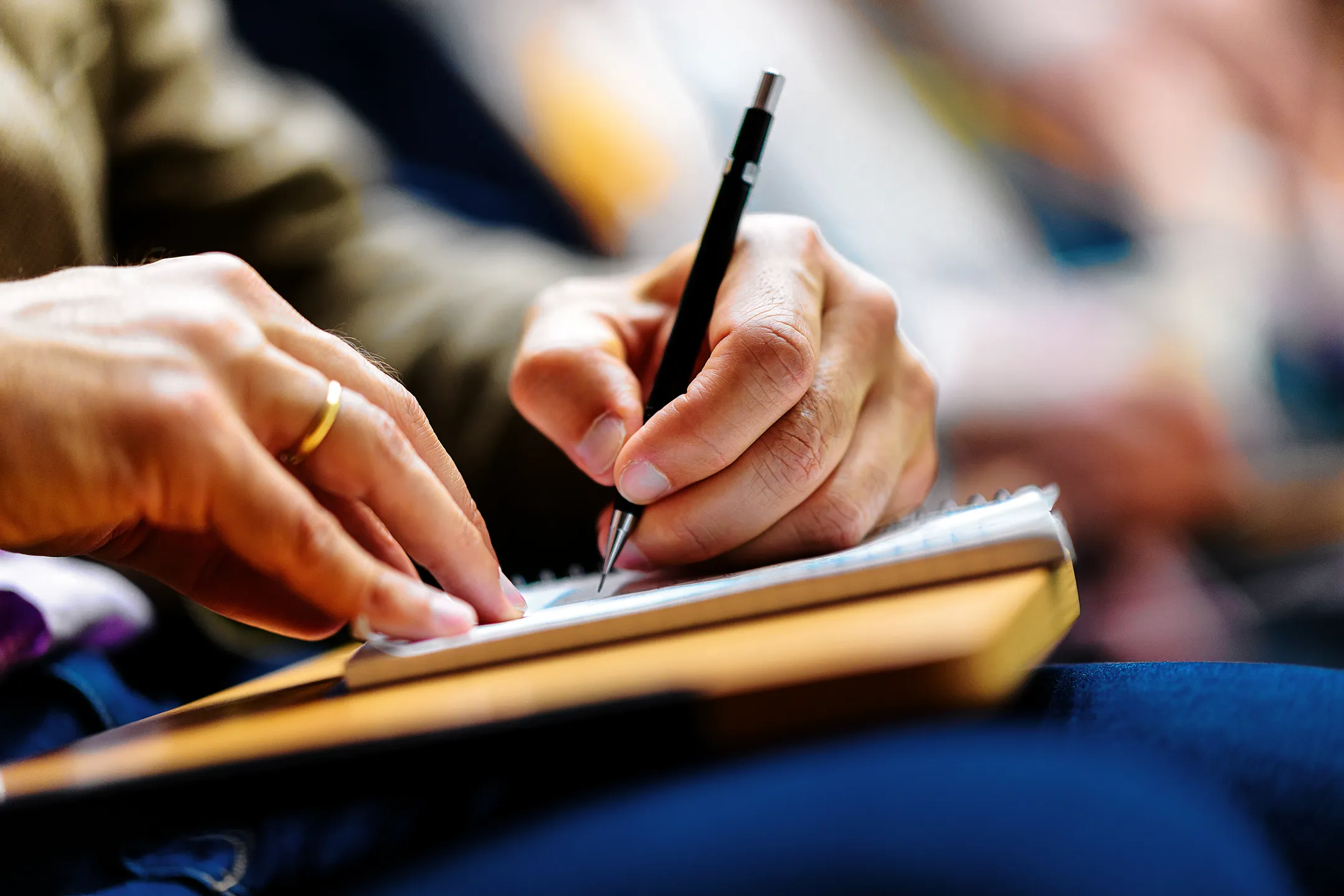 Participant prenant des notes lors d’une conférence sur l’industrie du verre durable à Grenoble