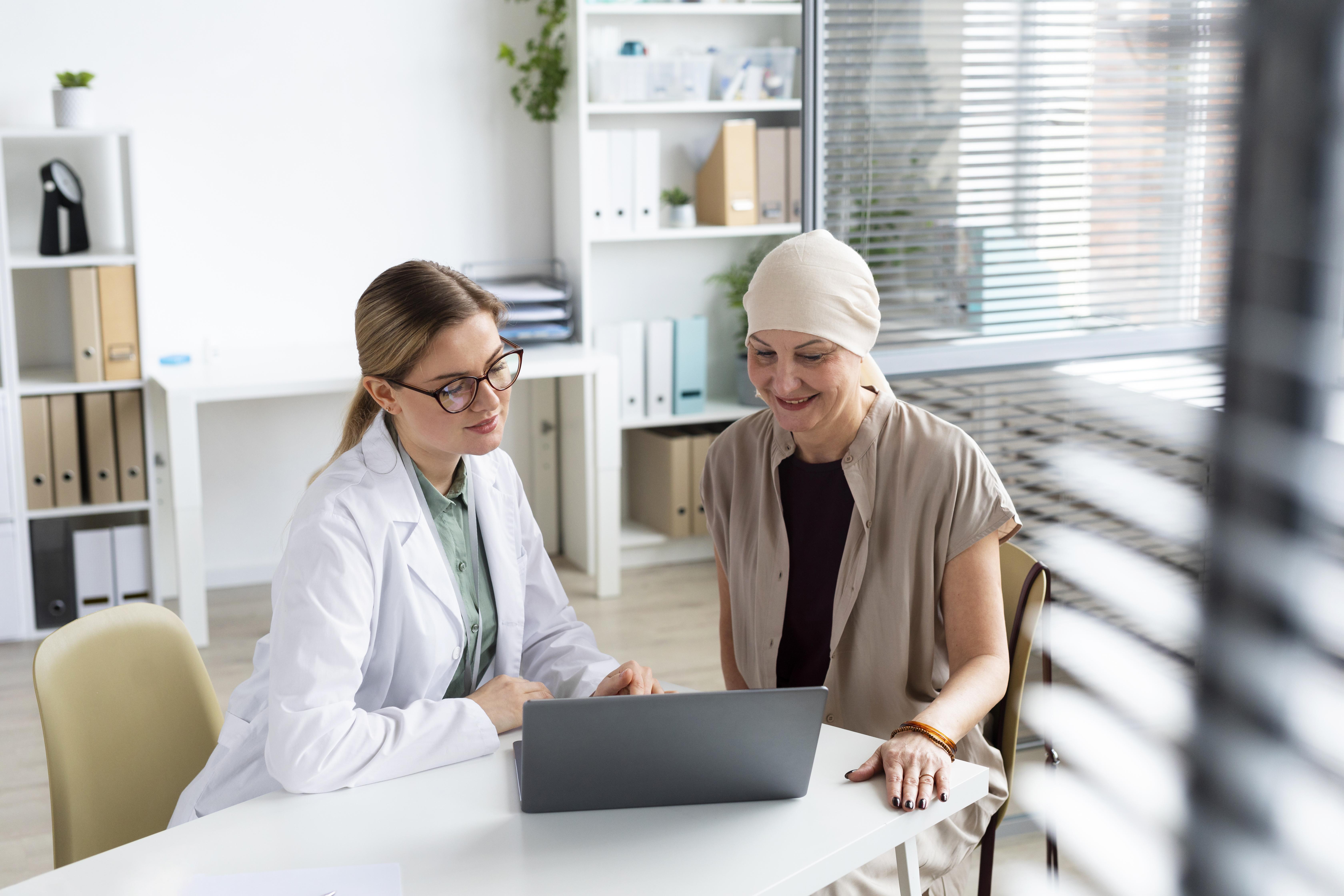 A cancer patient sitting with her doctor discussing her reports.