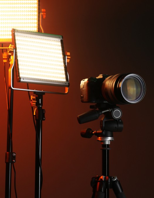 Two people using a camera and laptop for video production.