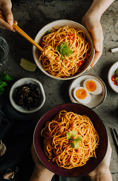Bowls of spaghetti with herbs and eggs