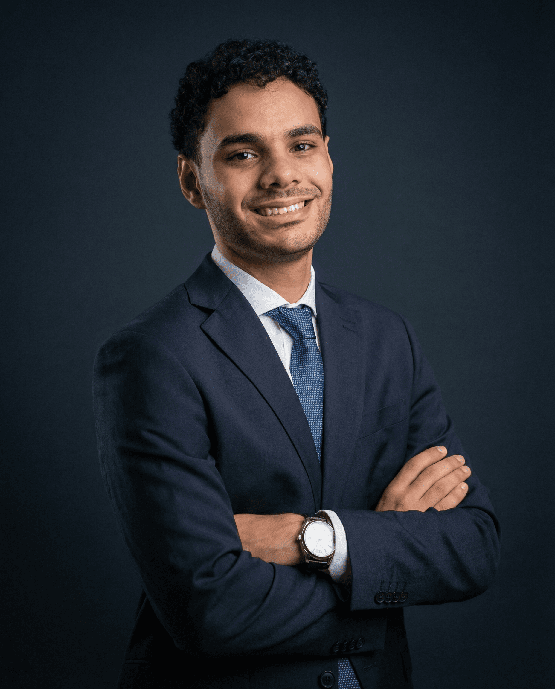 A woman in a business suit standing with her arms crossed