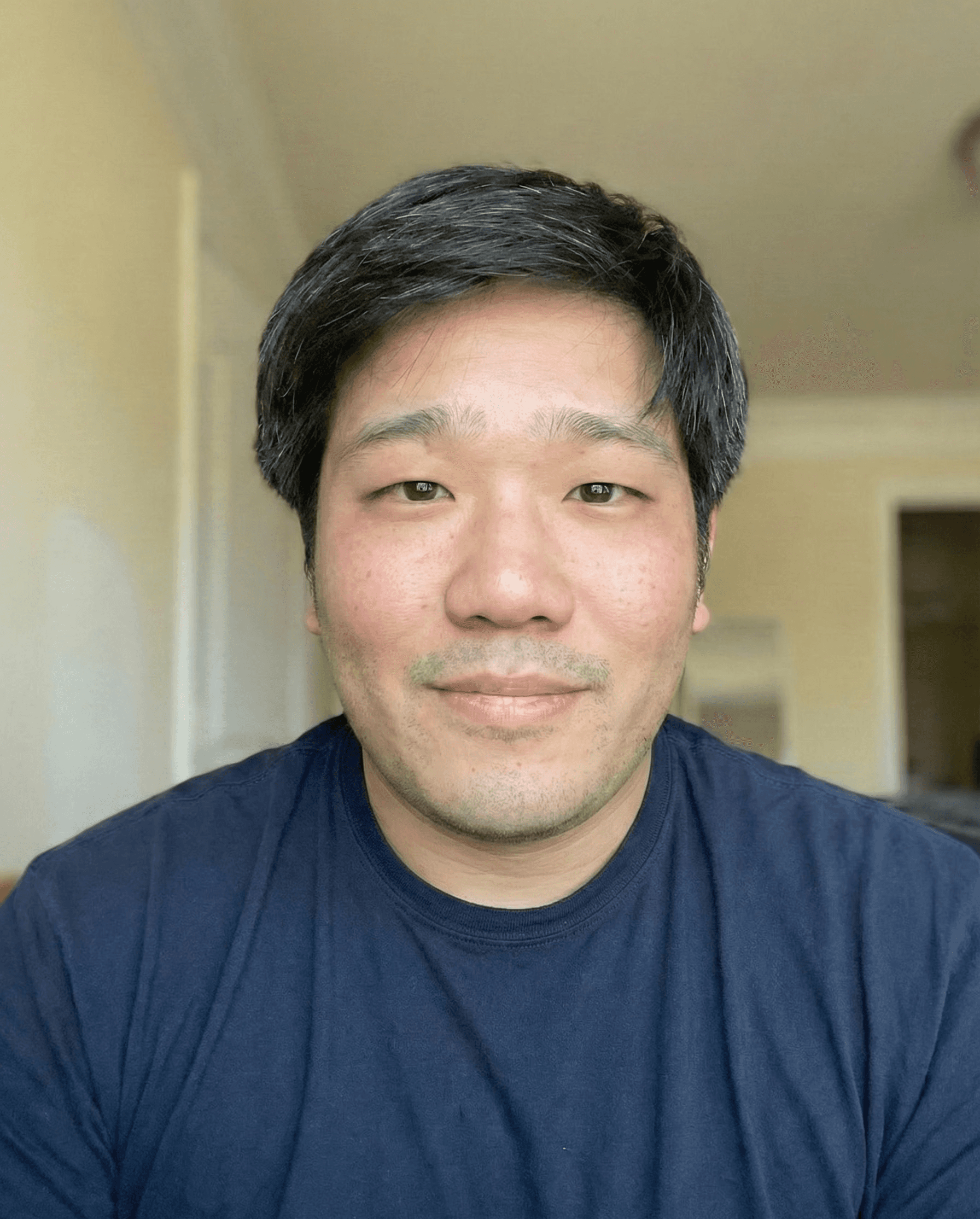 Stephen Sim, founder of Mighty Template, smiling in a navy t-shirt.
