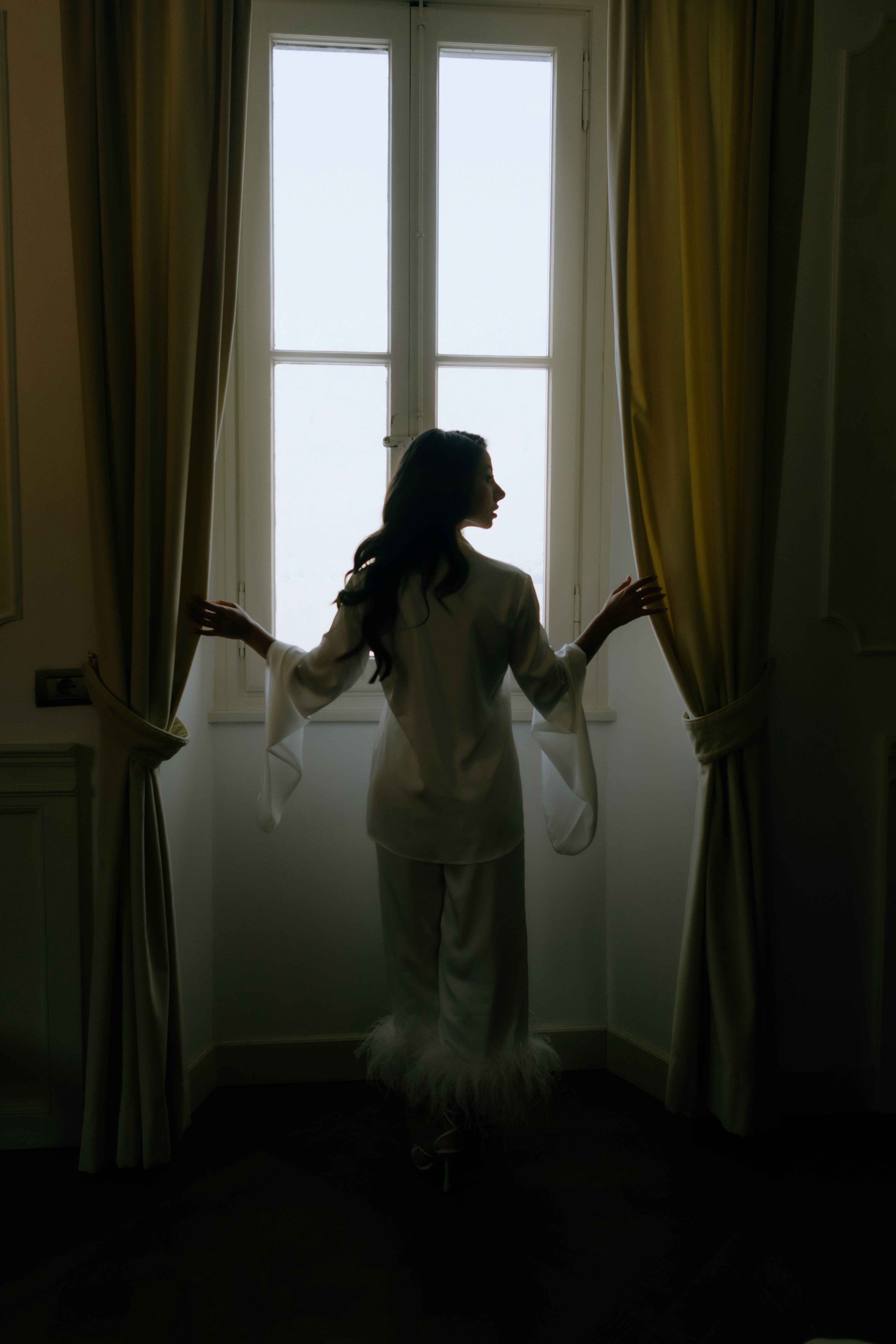 Flat lay of makeup essentials: brush, foundation, and powder on a beige background