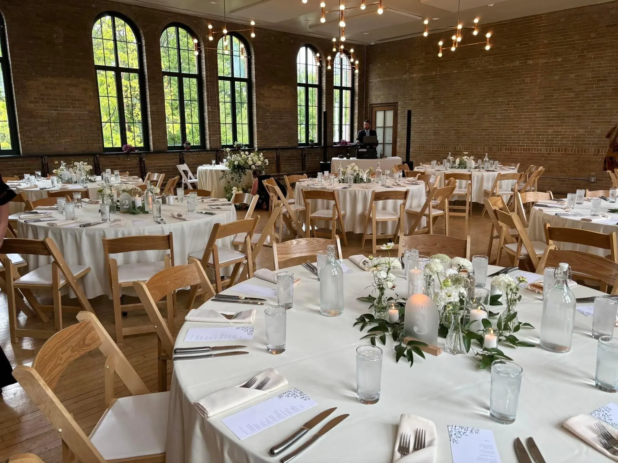 Wedding reception tables under arched windows at Understory