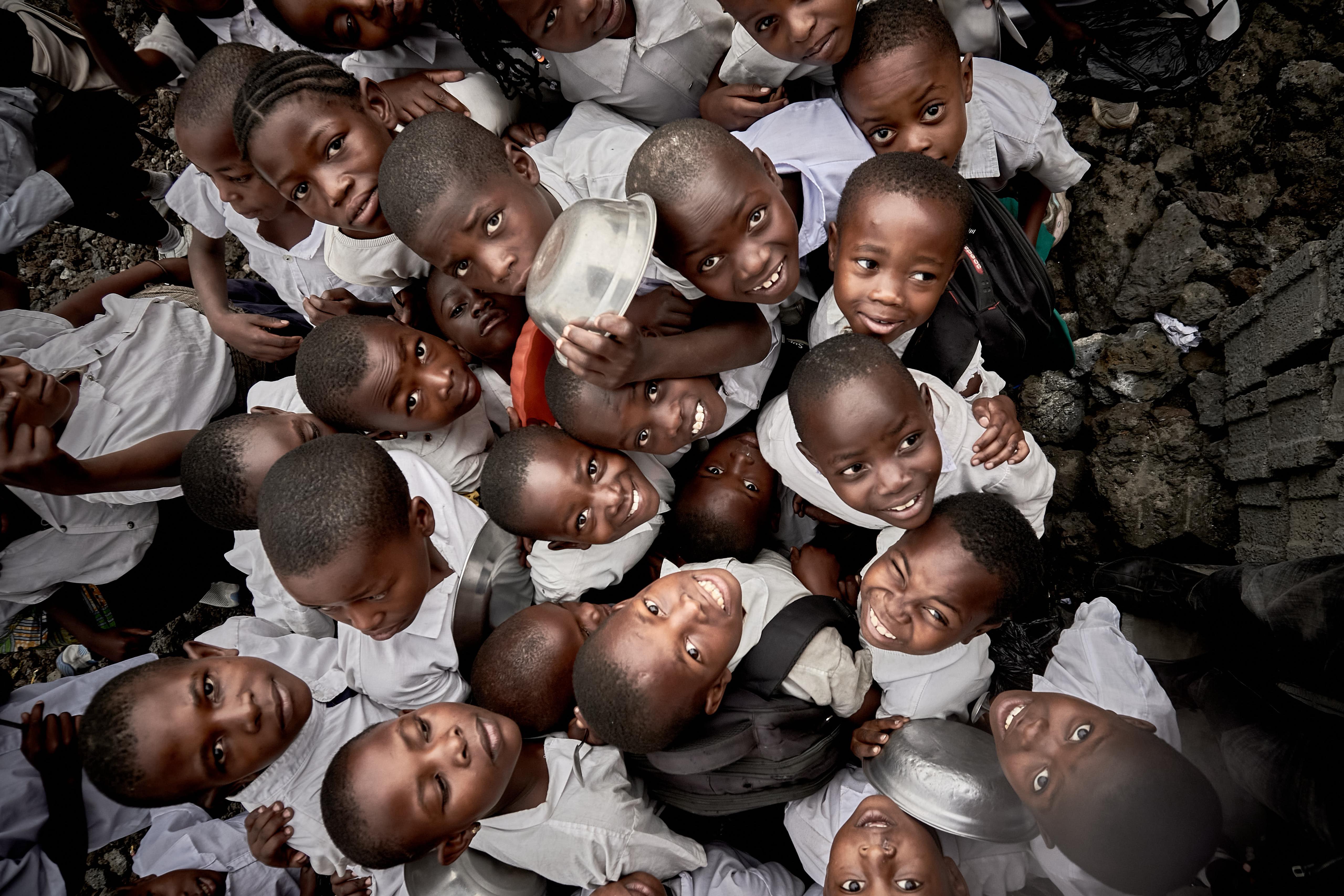 selective focus photography of woman standing surrounded by plants