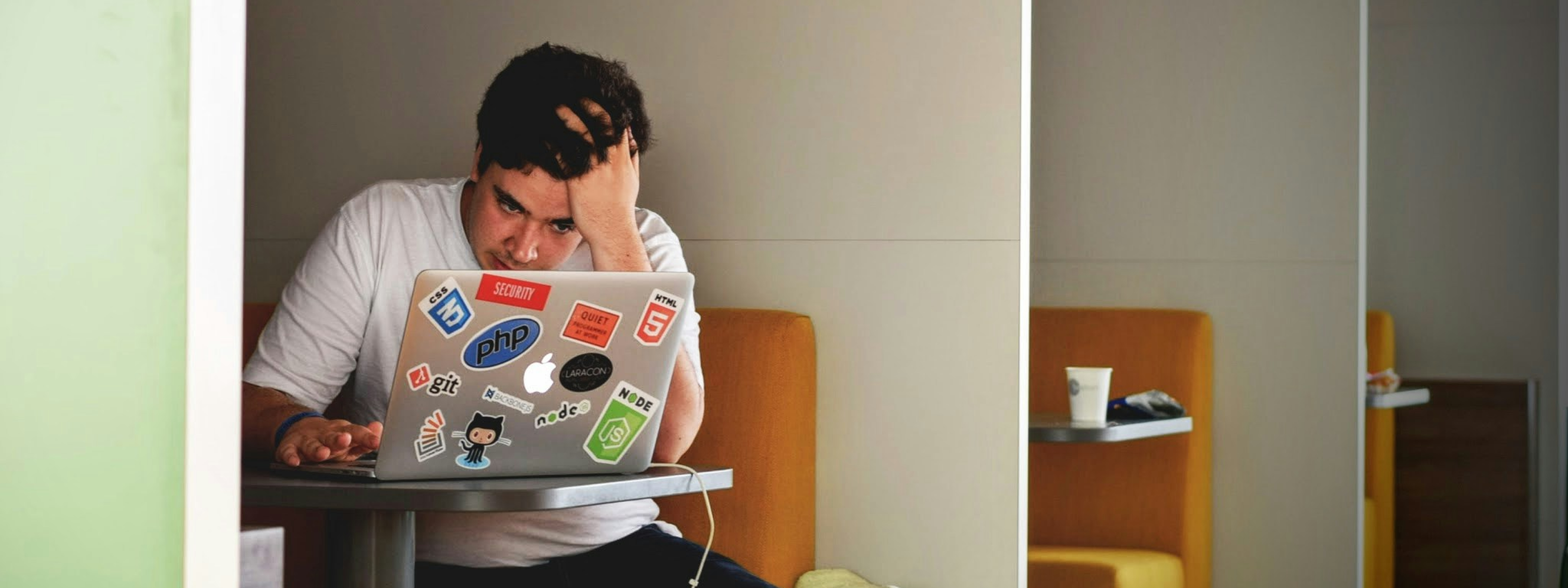 Photo of a stressed man on his laptop. Photo by Tim Gouw.
