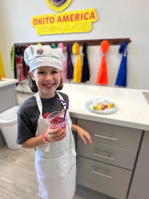 Kids in cooking class preparing sushi