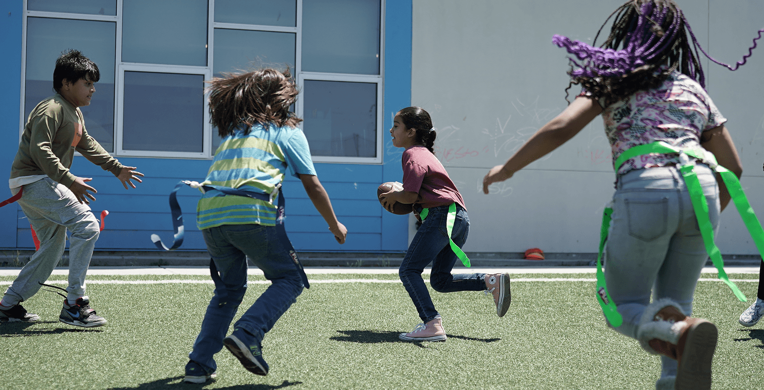 Children participating in an active HOKALI after-school enrichment activity that builds confidence and teamwork