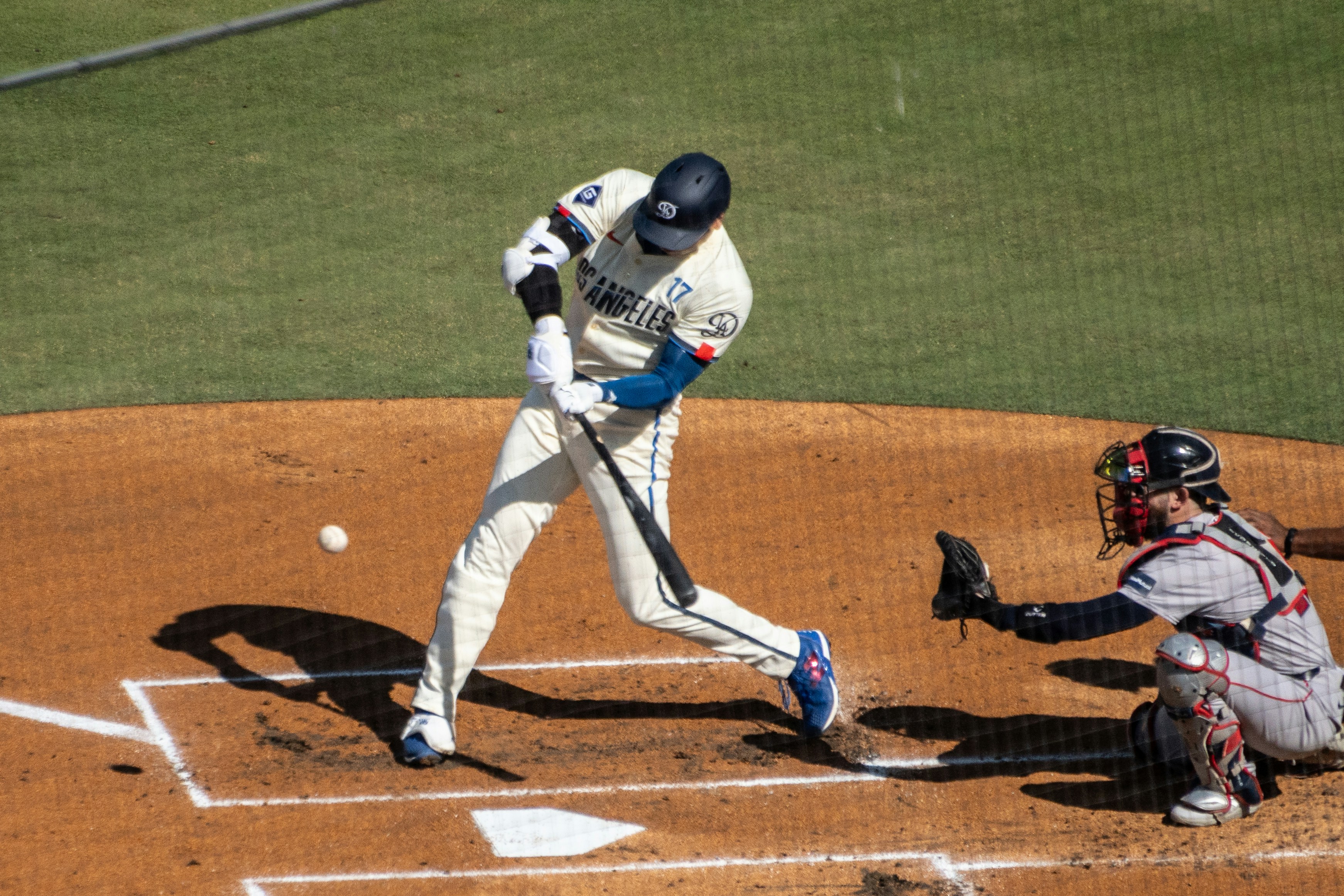 A baseball player swinging a bat at a ball