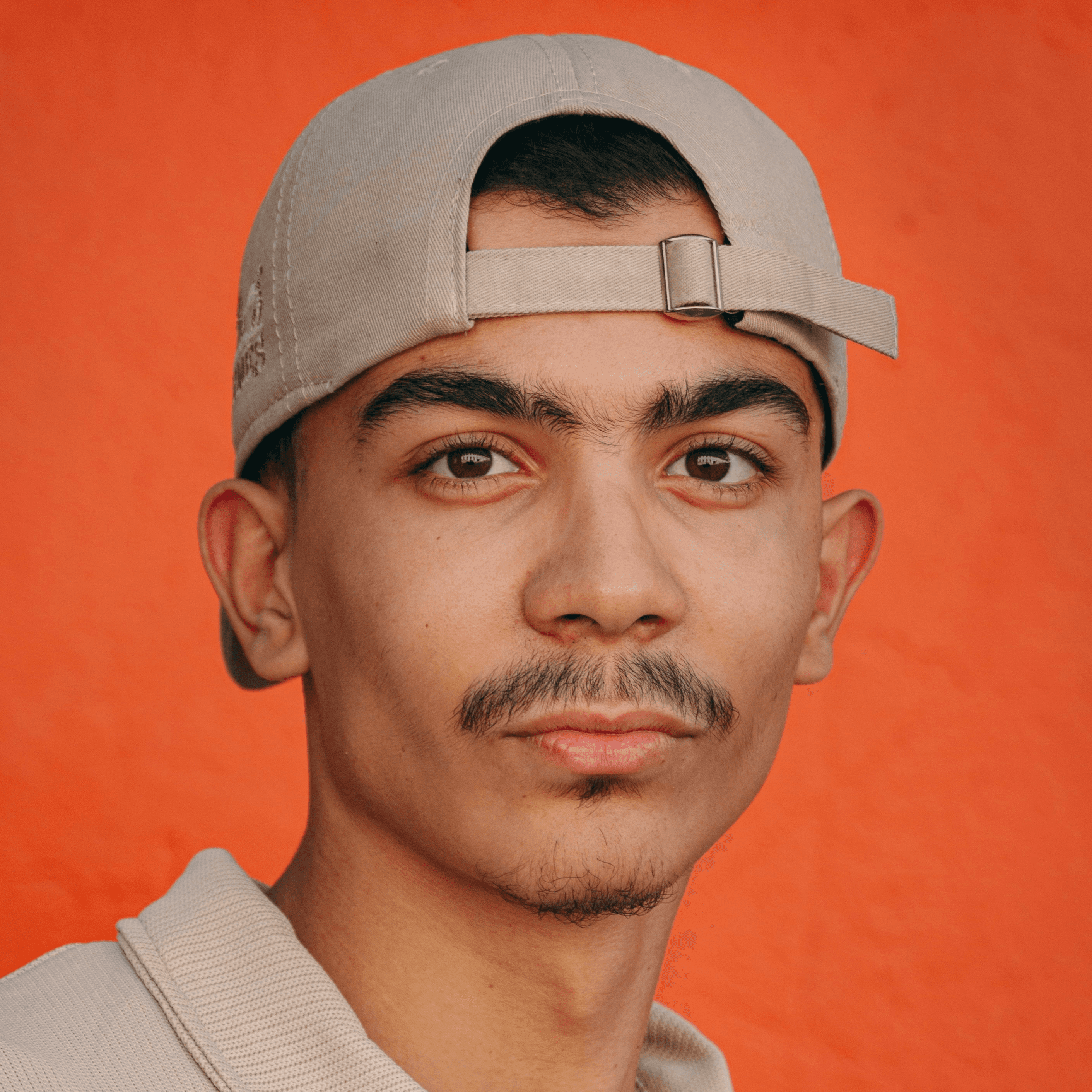 A man with a mustache wearing a hat