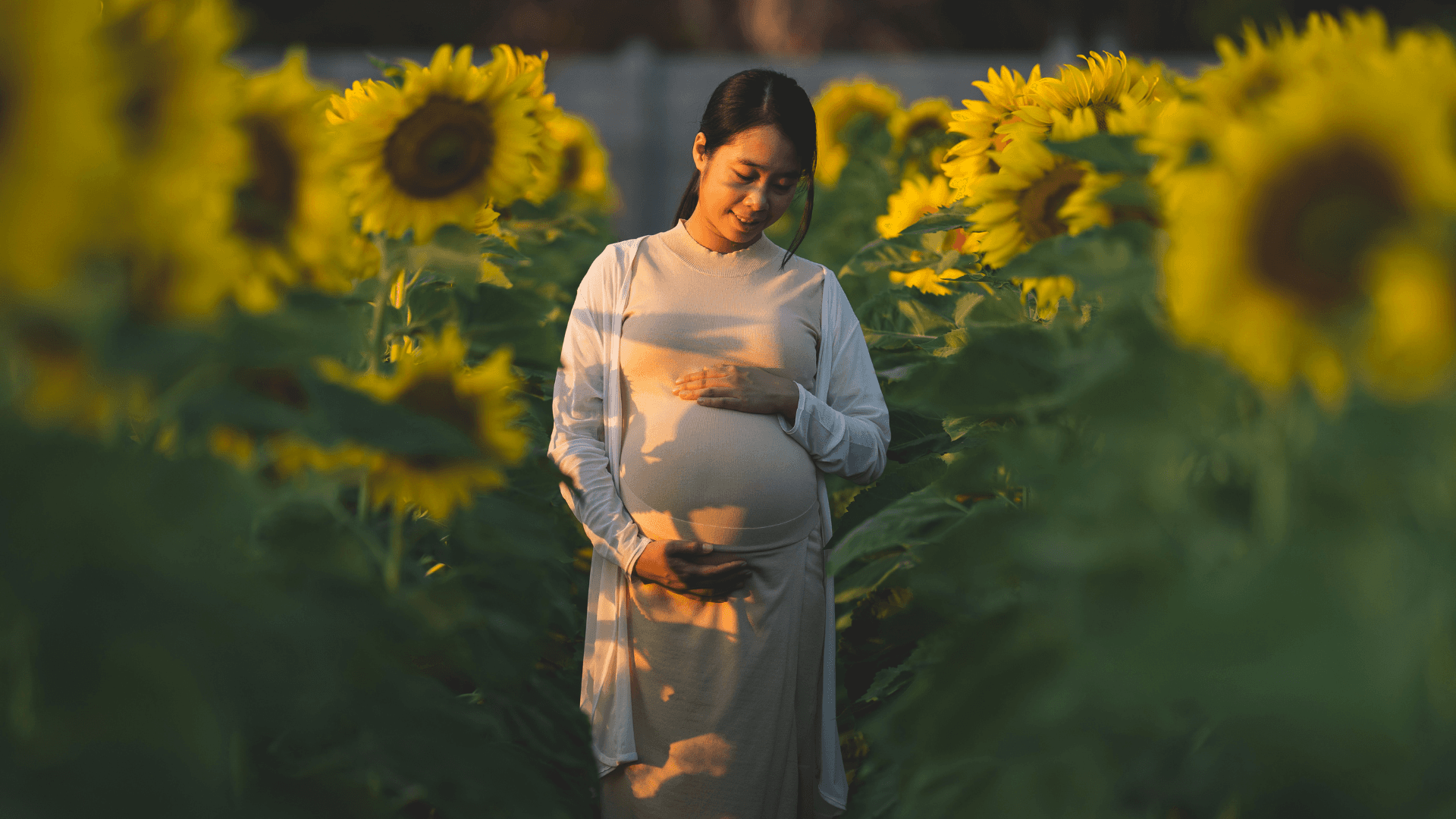 Three children jumping in burlap sacks during a race.