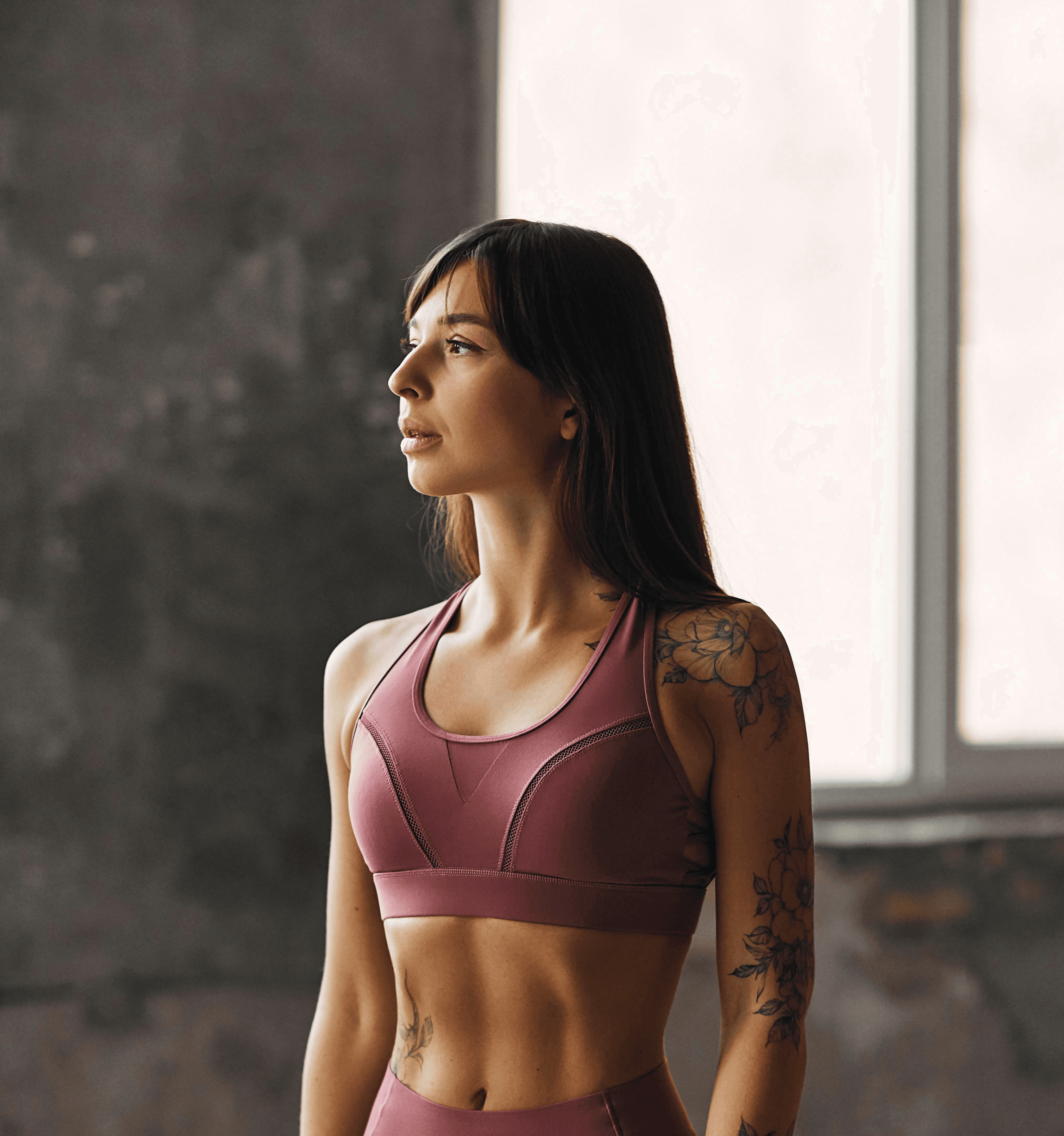 woman in pink sports bra and pink leggings