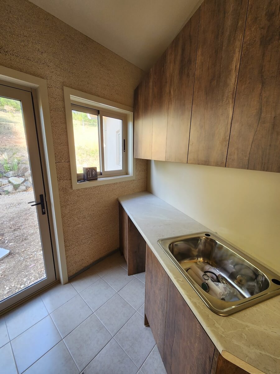 A photo of a sink and wash area featuring a beautifully designed wall