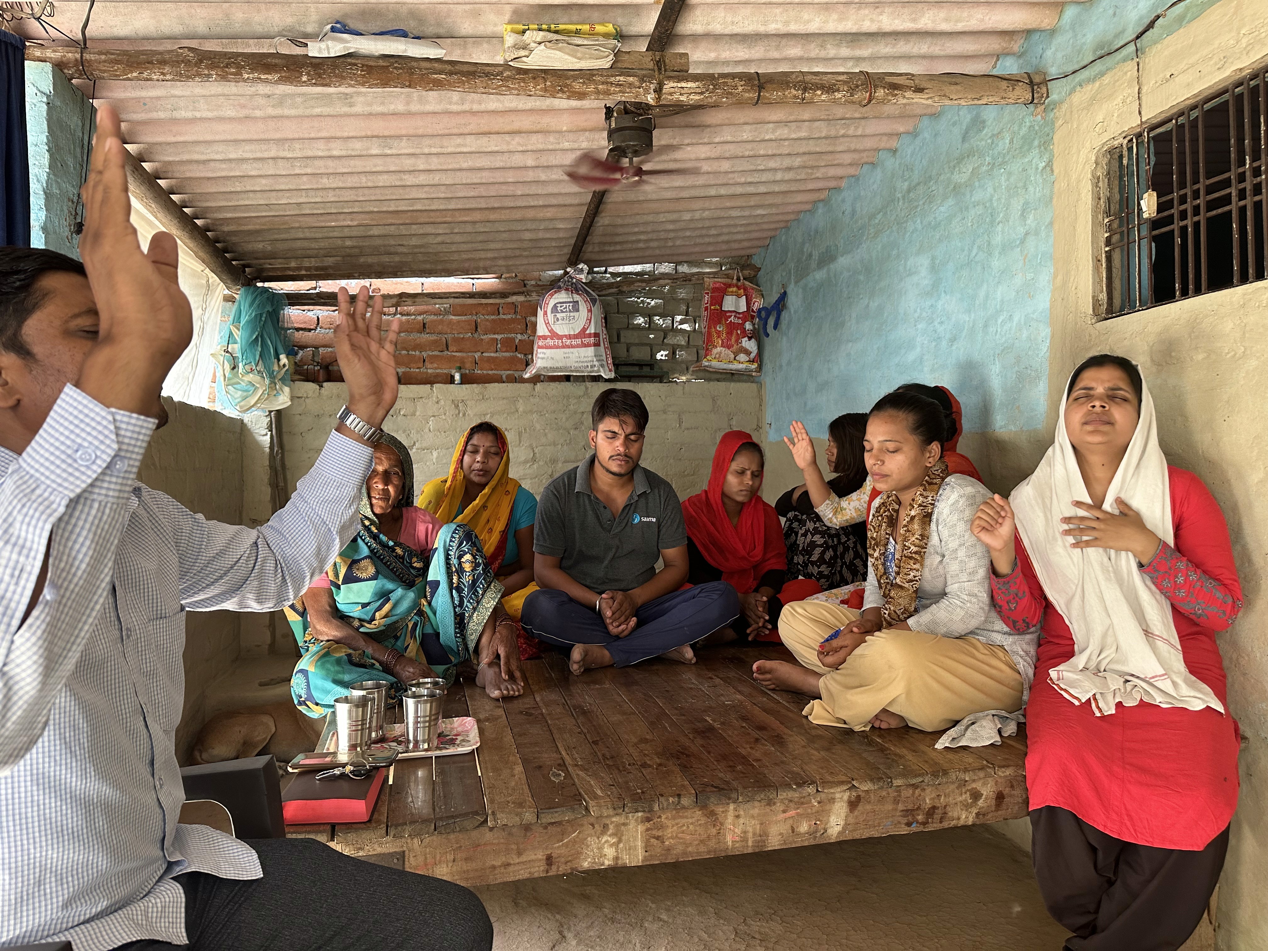 person in red sweater wearing silver ring