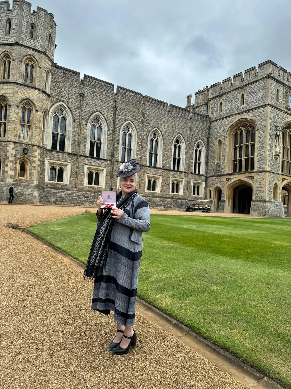 Portrait of Solange Urdang receiving her OBE as recognition of her efforts.