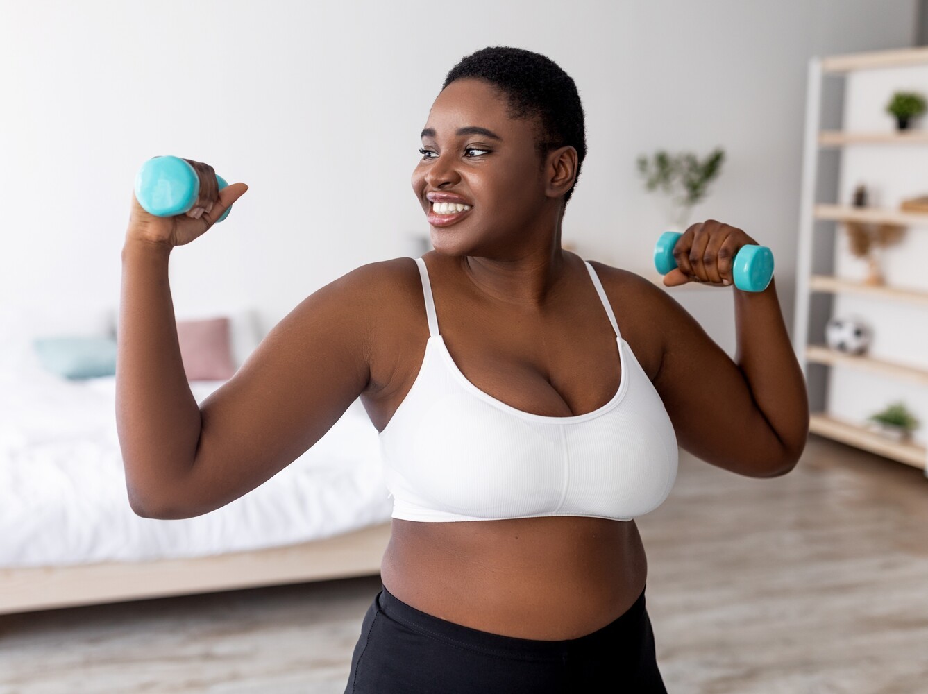 woman using dumbbells to gain strength to assist with her recommended steps per day by age to lose weight