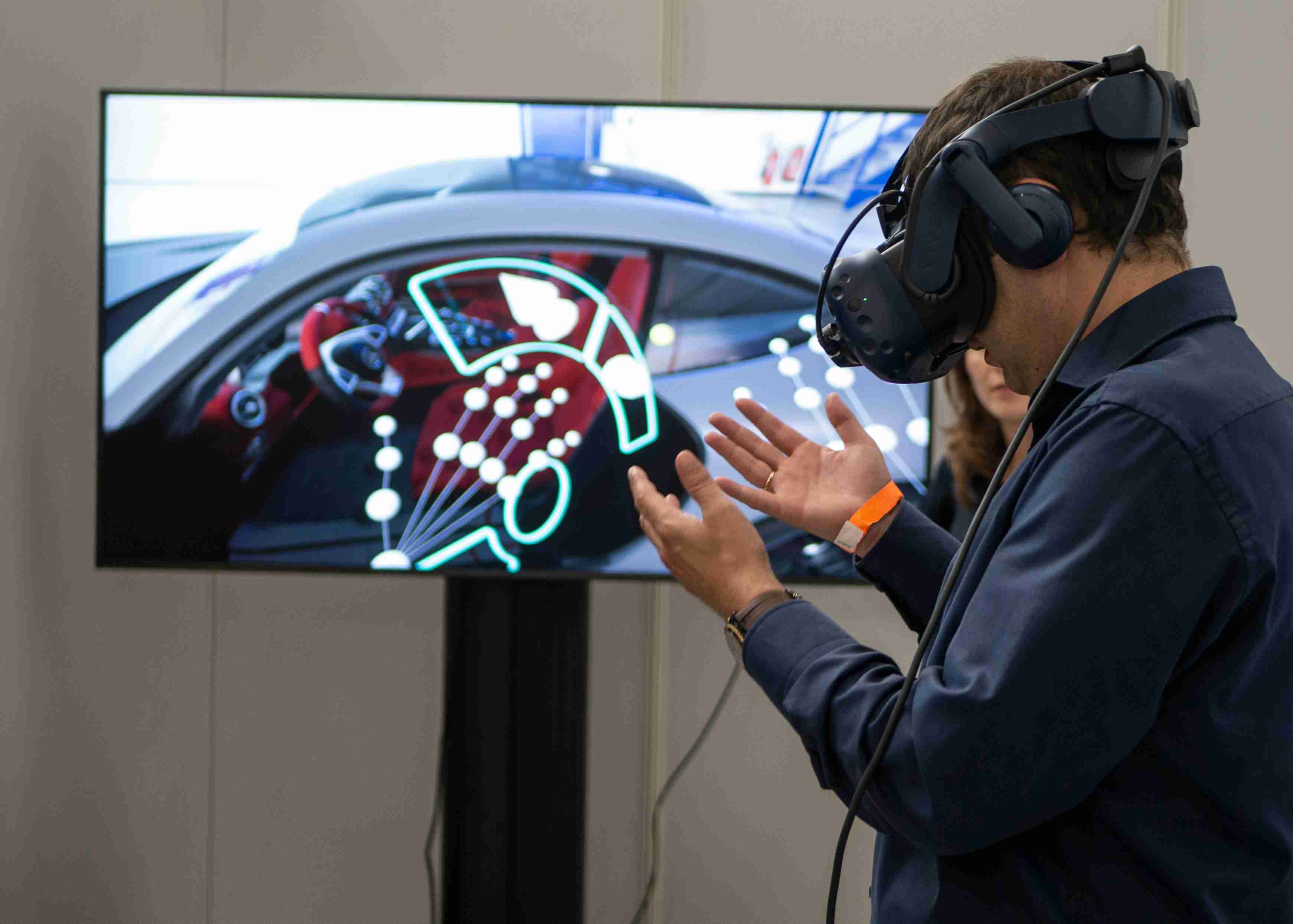 Man interacting with augmented reality dashboard in virtual car setup