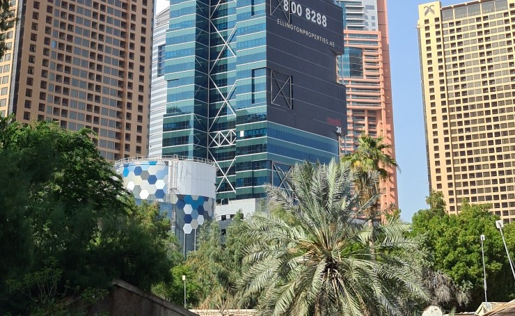 Large scale branding on a luxury real estate skyscraper, highlighting top-tier property investment options.