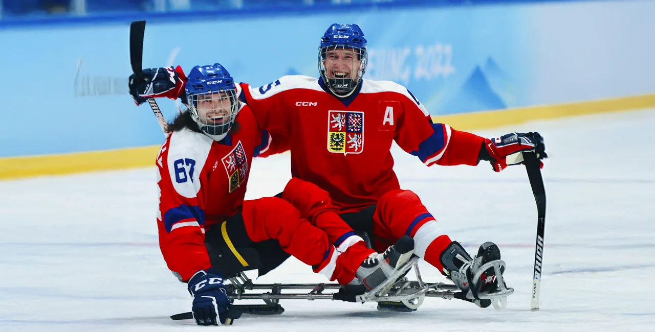 Czech para ice hockey players celebrating on the ice.