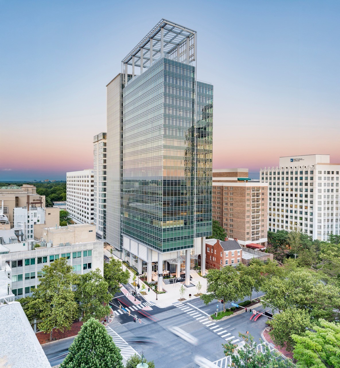 An image of the Avocet Tower from far away. The background is colored with dawn hues. This is where Potomac is headquartered.