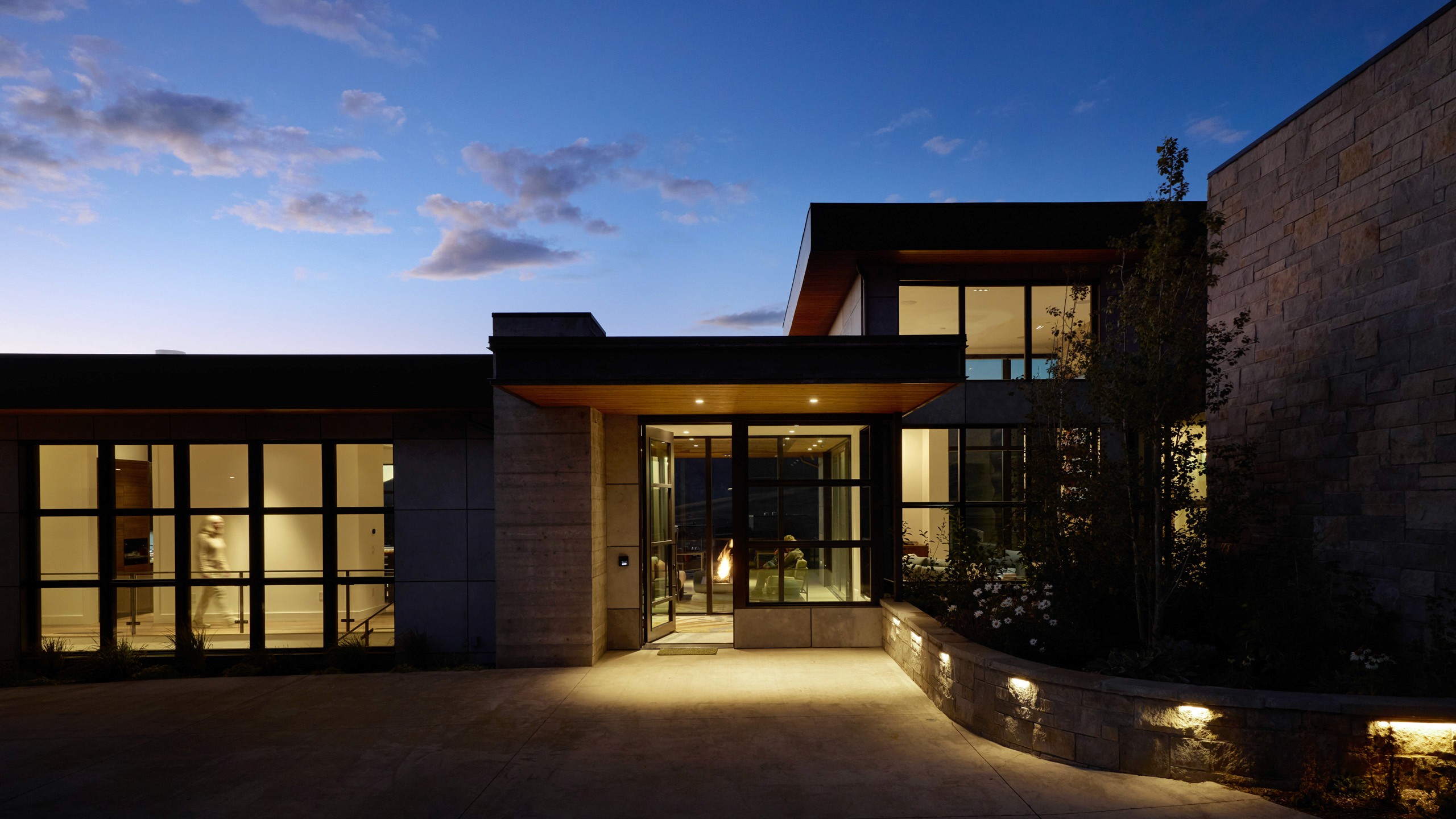 Modern house with large windows at dusk.