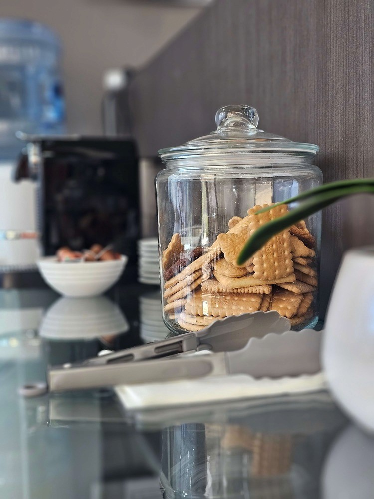 A mediation room with six seats and a table, beside a large window