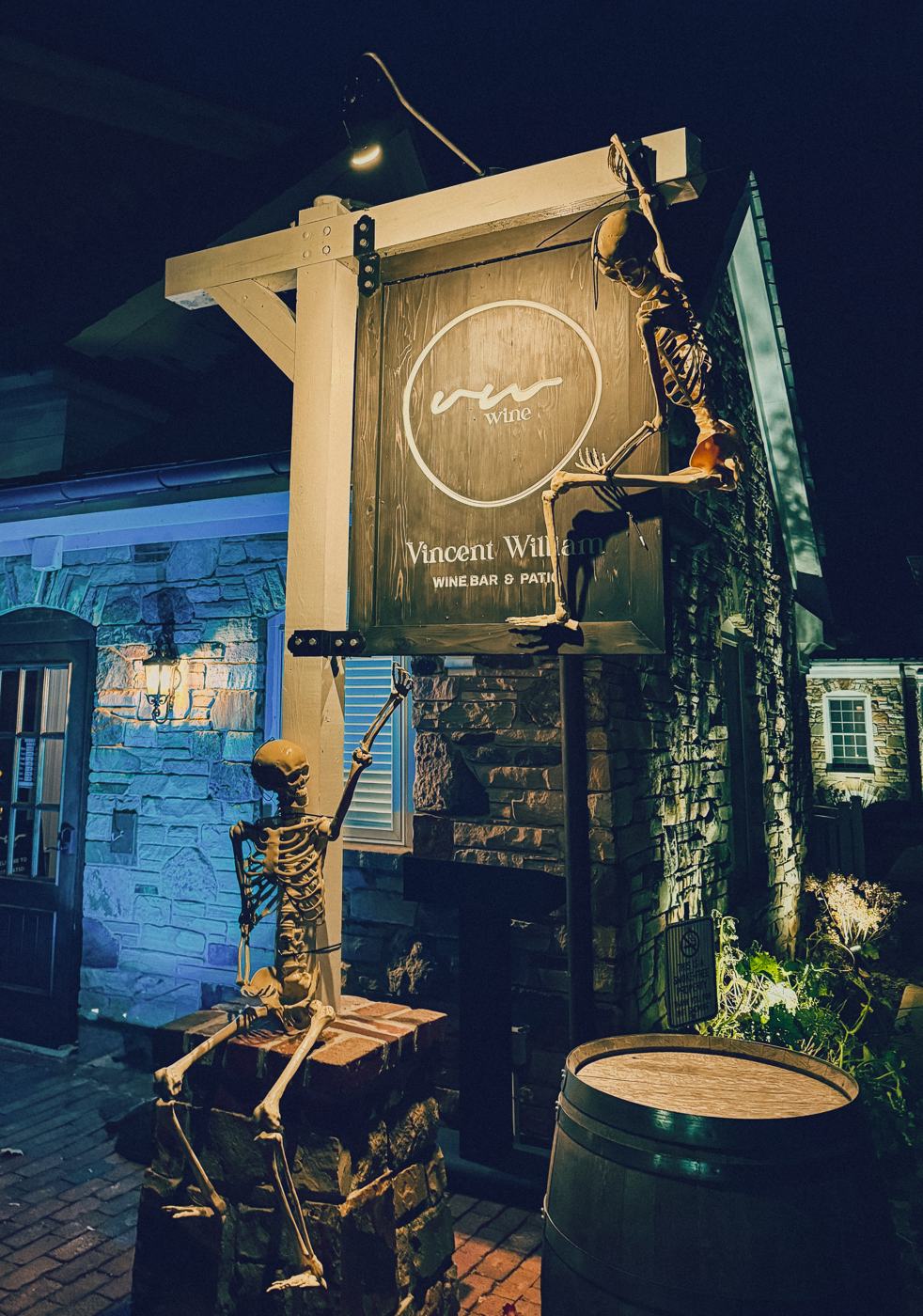 The Vincent William sign at night with skeletons climbing the post