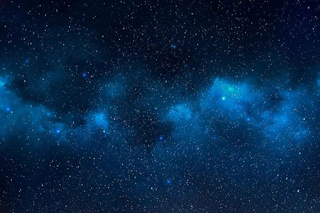 Dense blue-white star field in deep space.