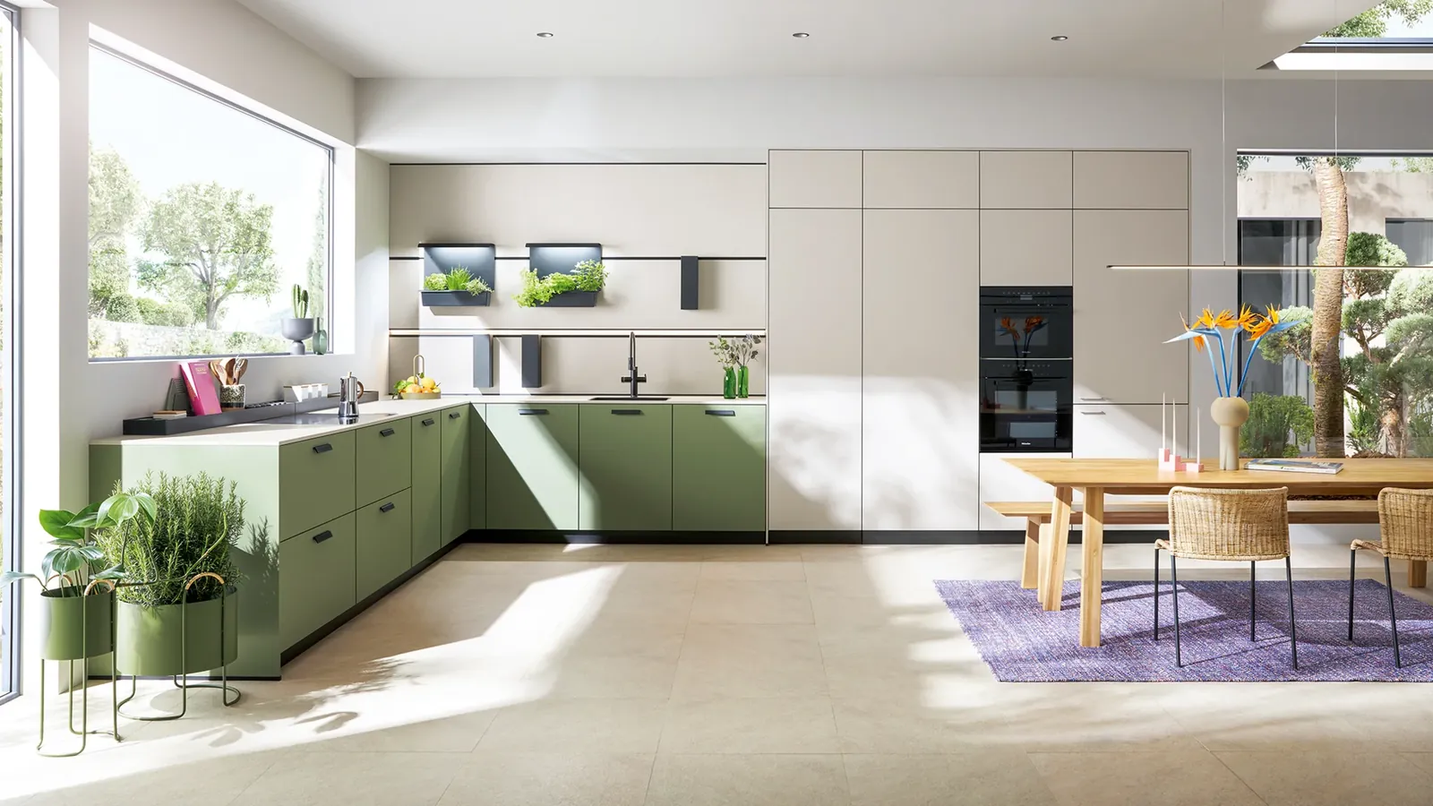 Cuisine next125 avec façades vert olive, colonnes claires et table en bois