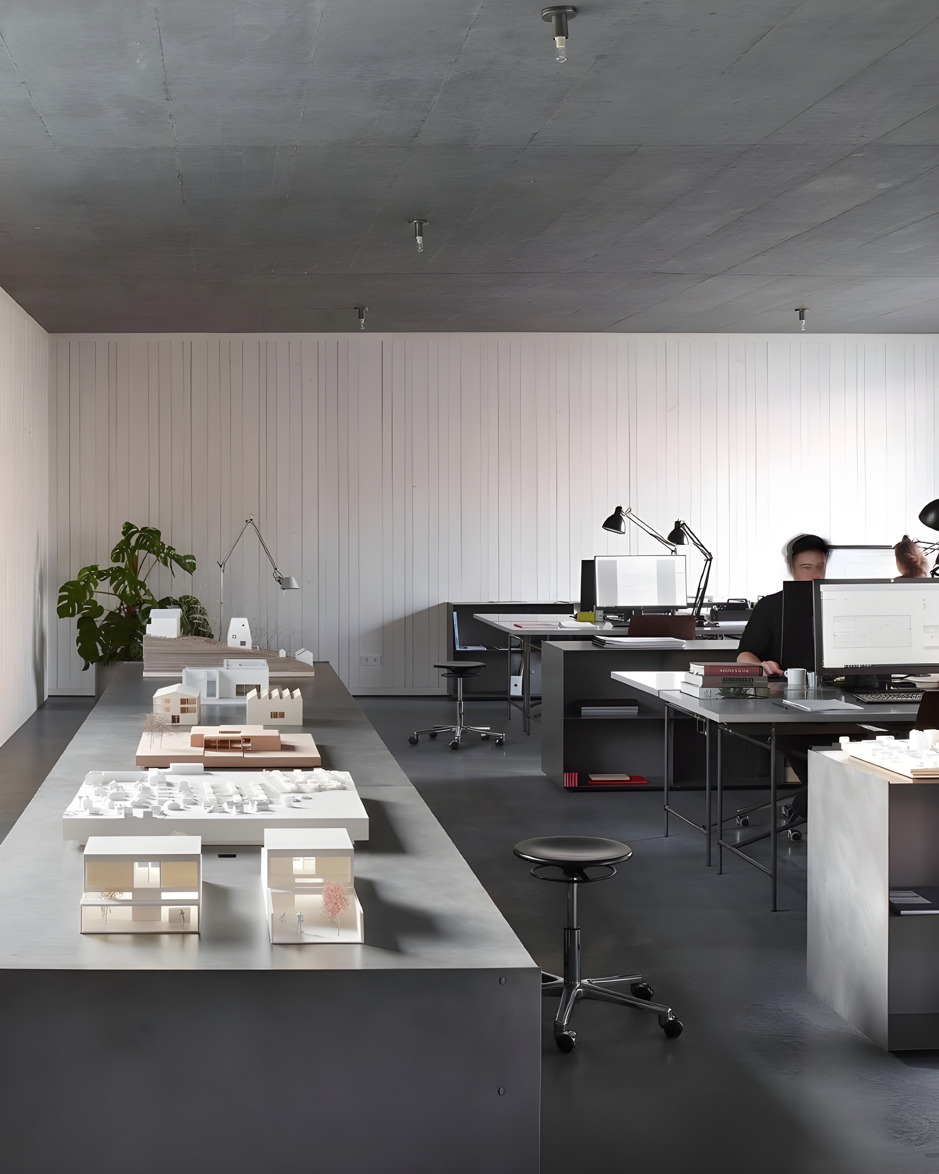 Open-plan living space with sculptural curved walls and soft ambient lighting