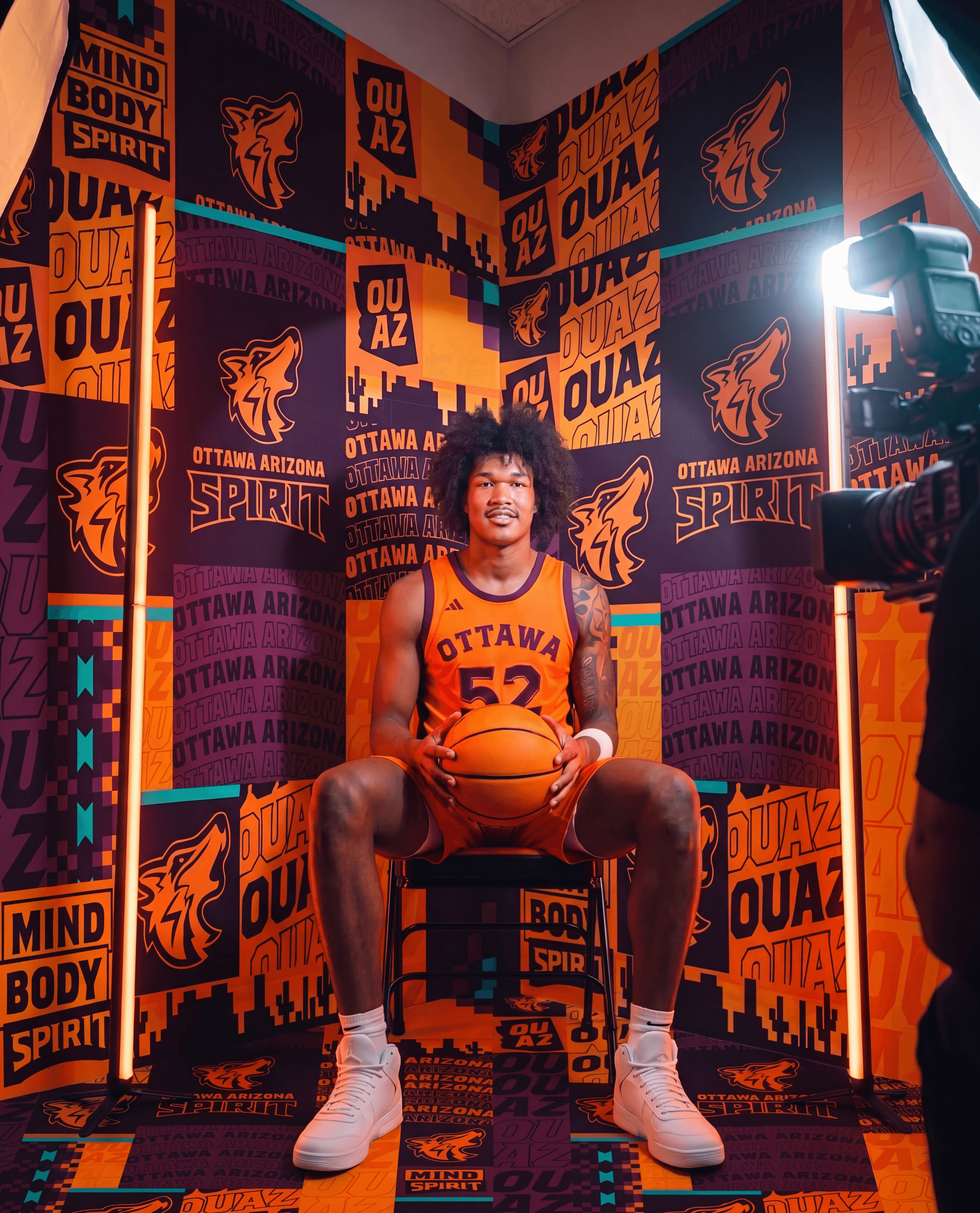 Player standing in front of OUAZ Media Day backdrop design