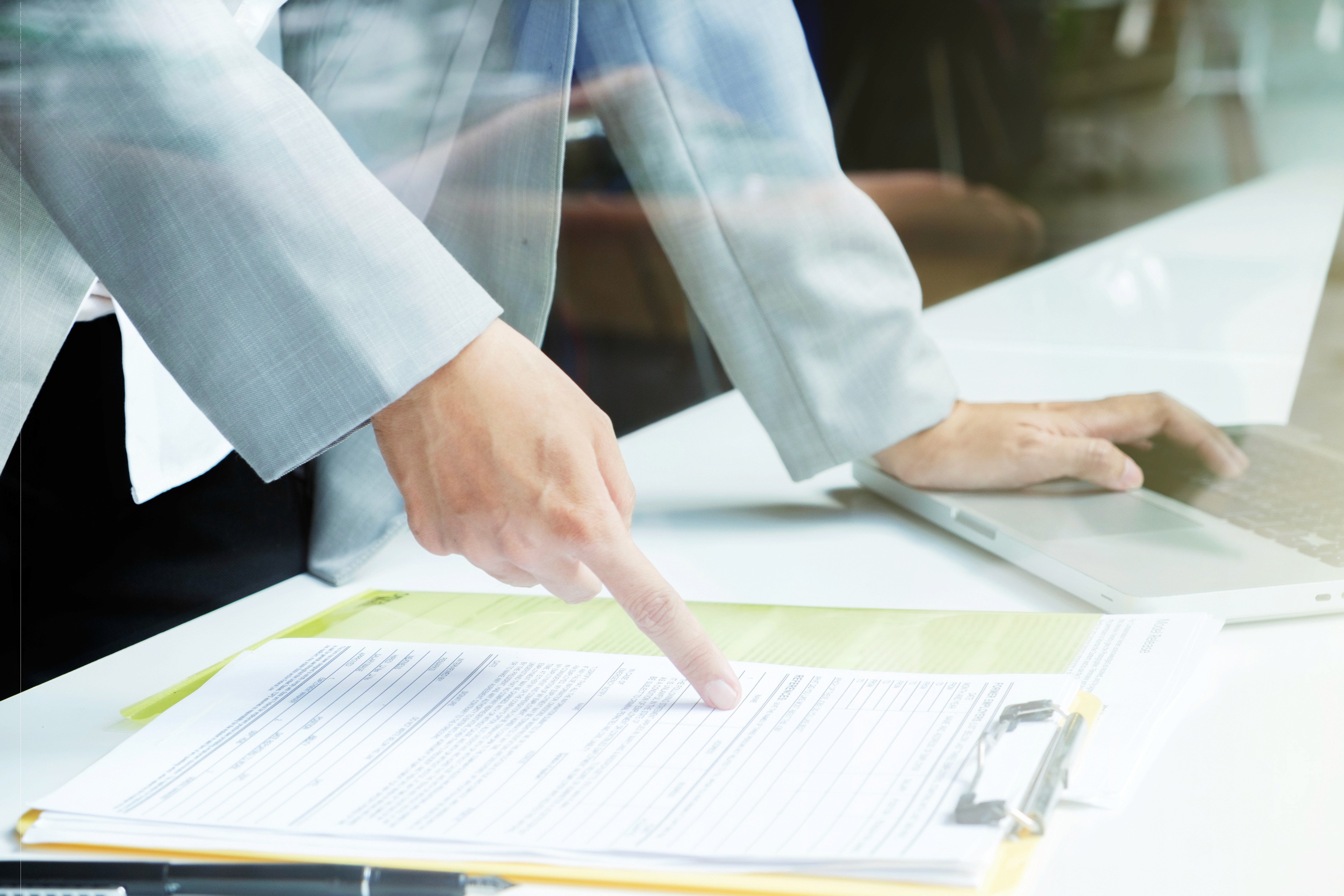 A businessman double-checking documentation for product registration in Dubai.