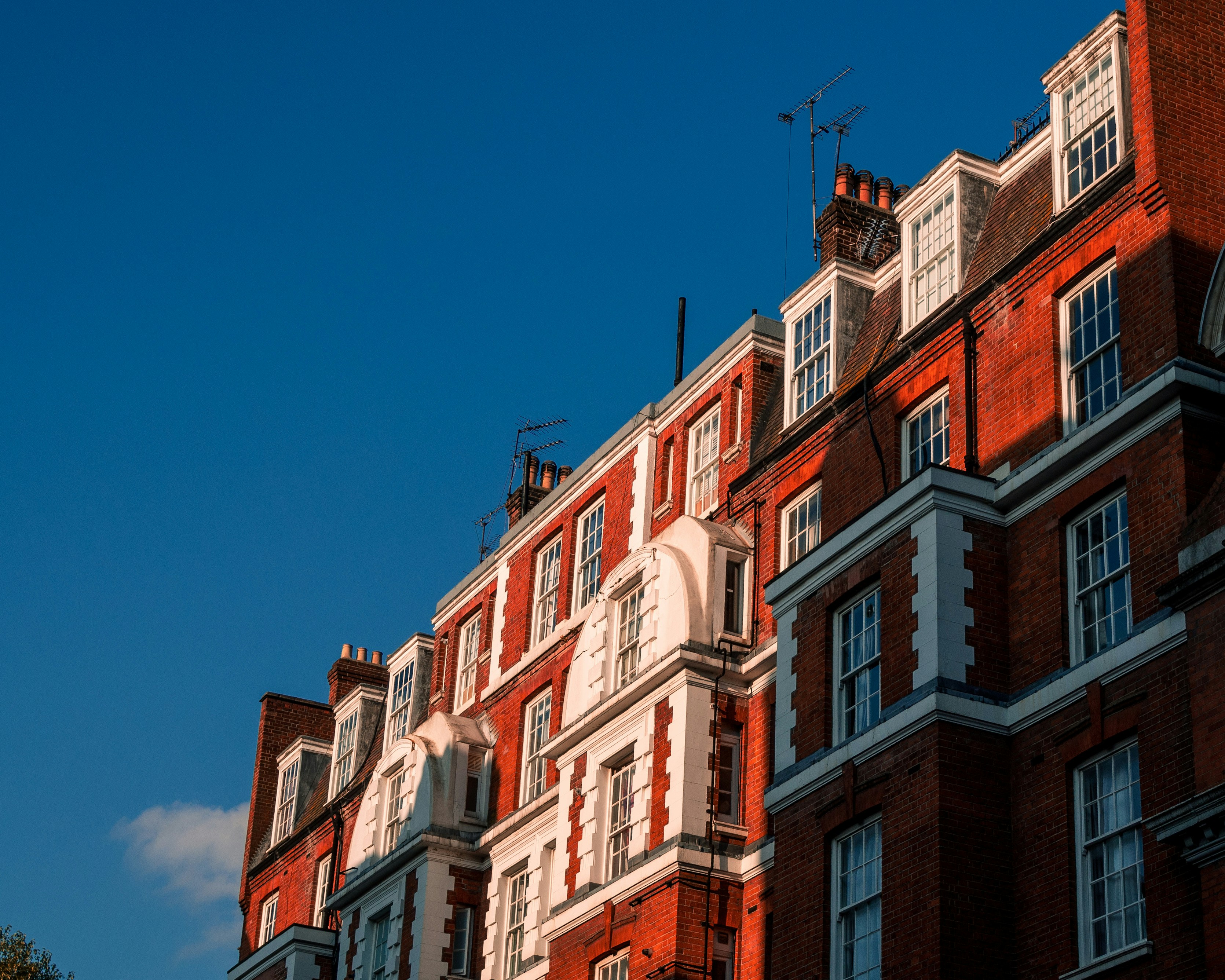 brown and white concrete building under blue sky during daytime