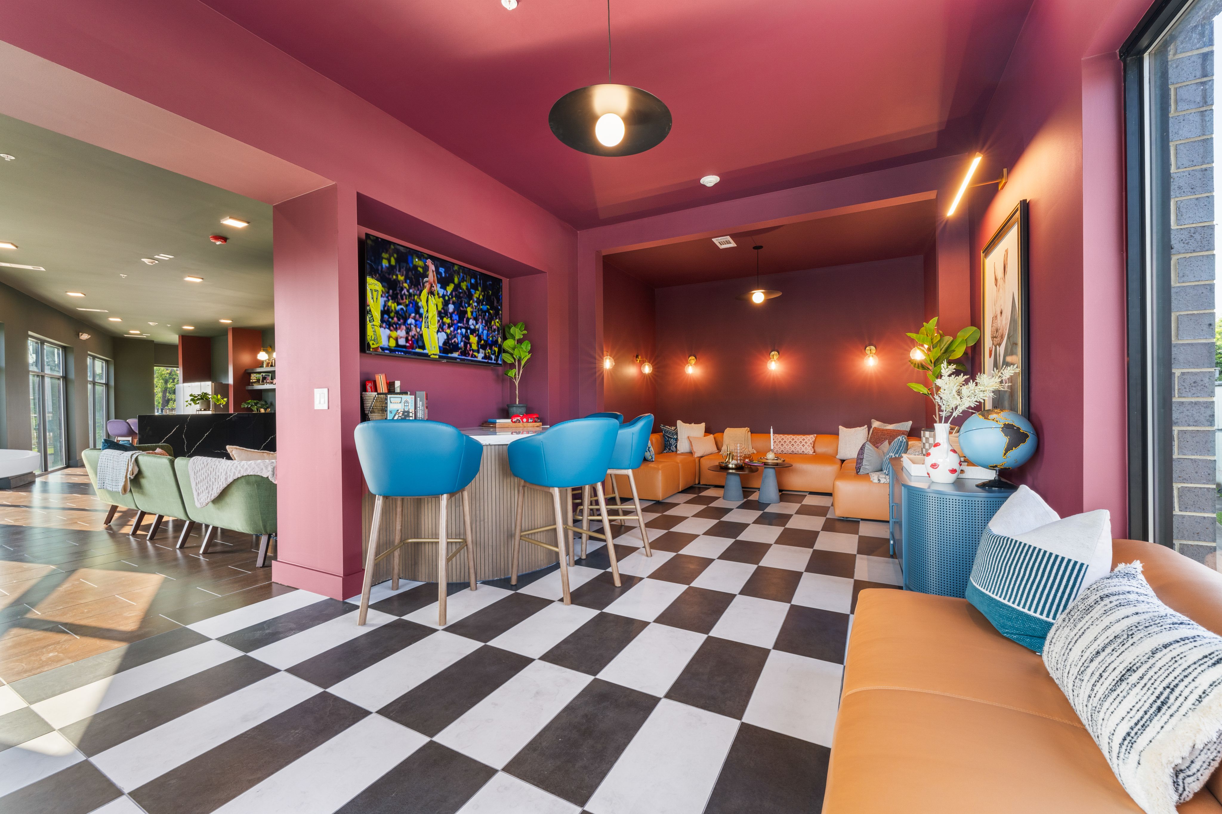 The Den, featuring modern decor and a welcoming atmosphere for diners.