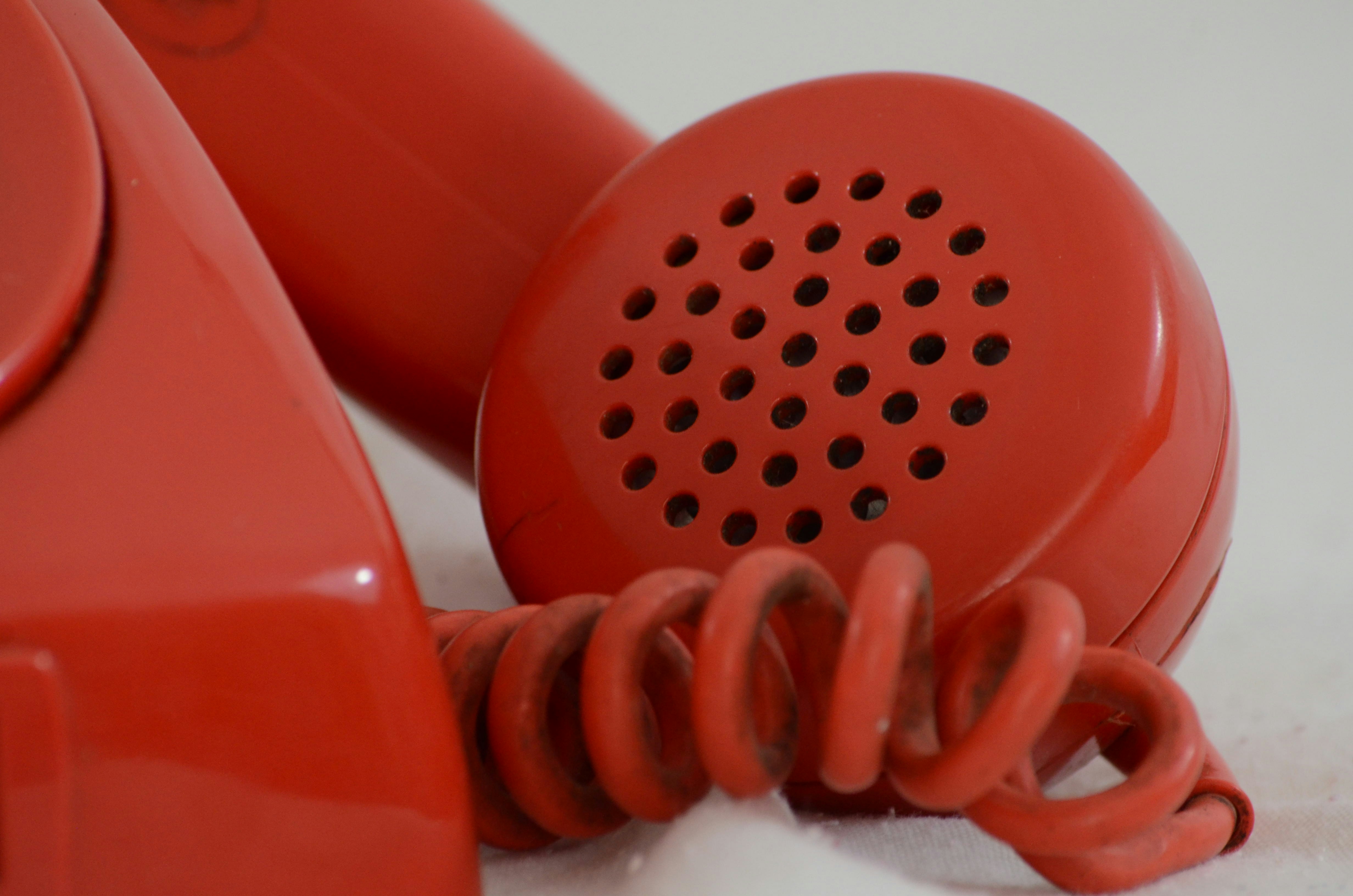 closeup shot of a red hotline phone