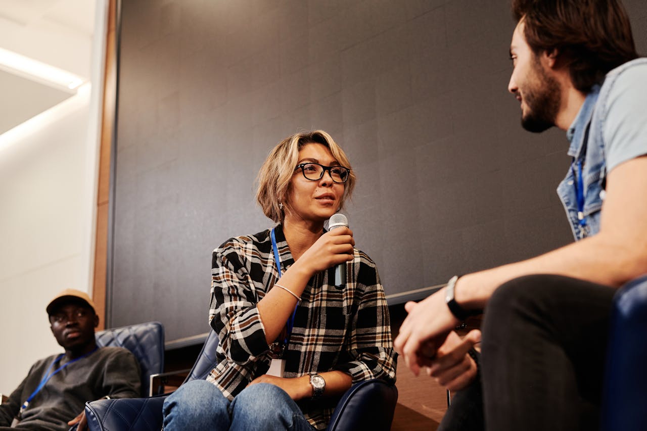 Woman talking to a Man using Mic