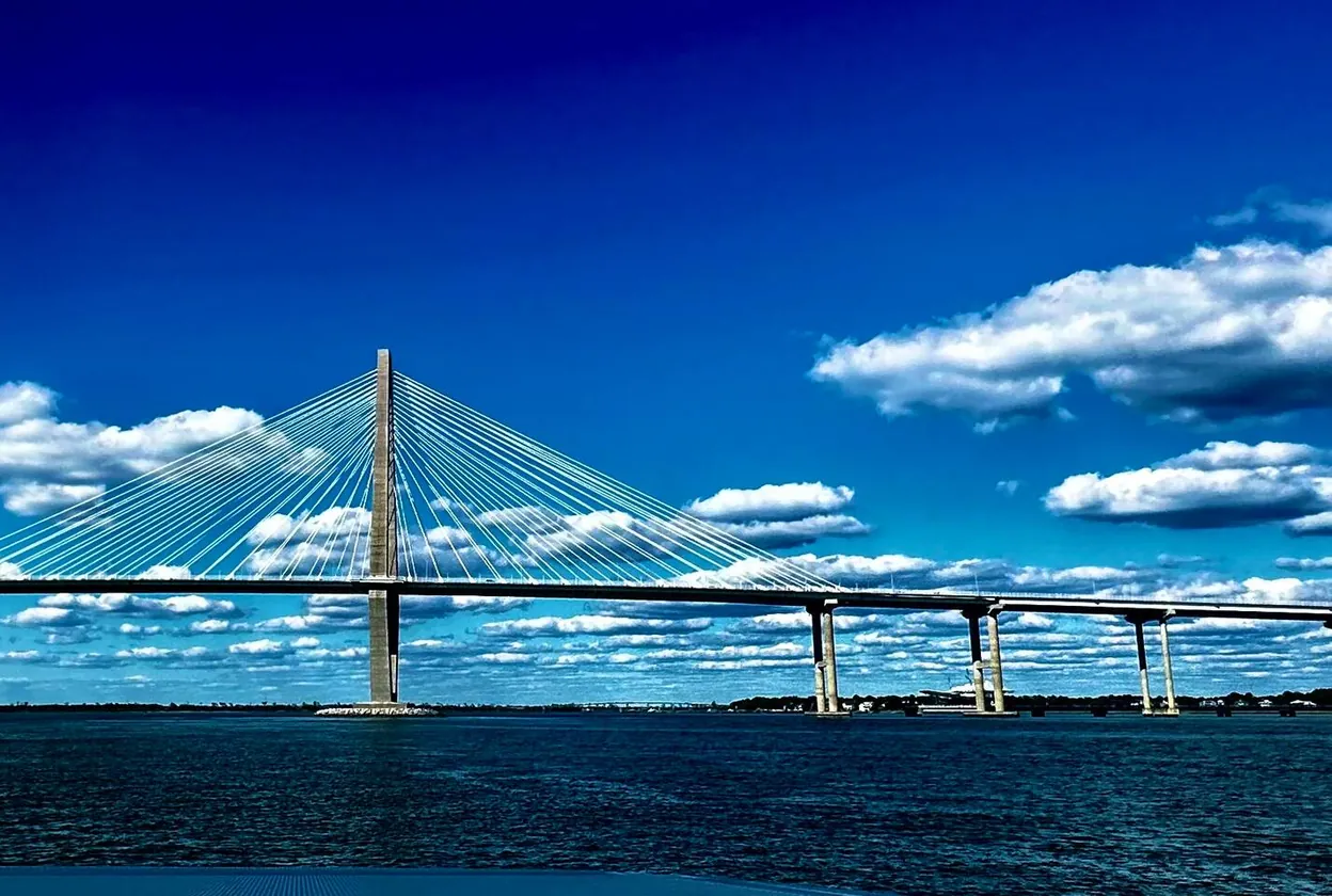 The Ravenel Bridge under a blue sky over Charleston Harbor