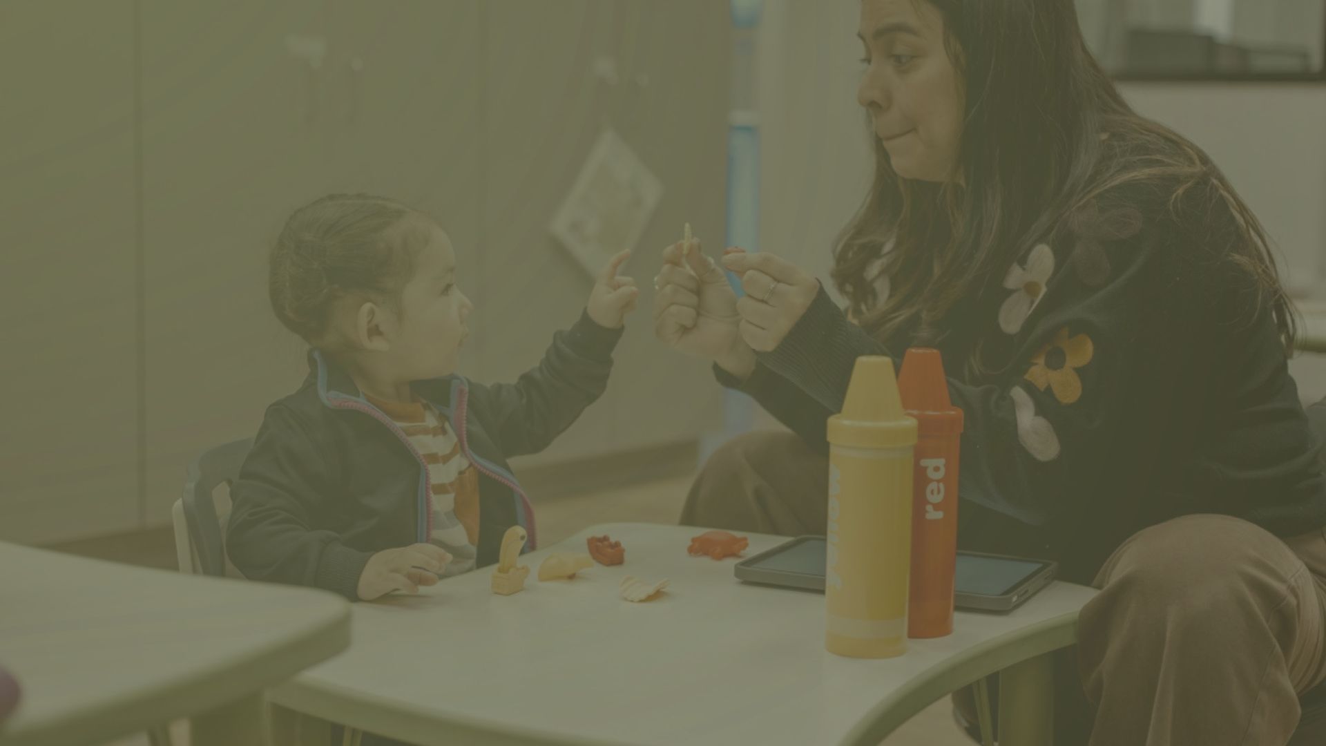 A therapist and child engage in play-based therapy at Leaps & Bounds.