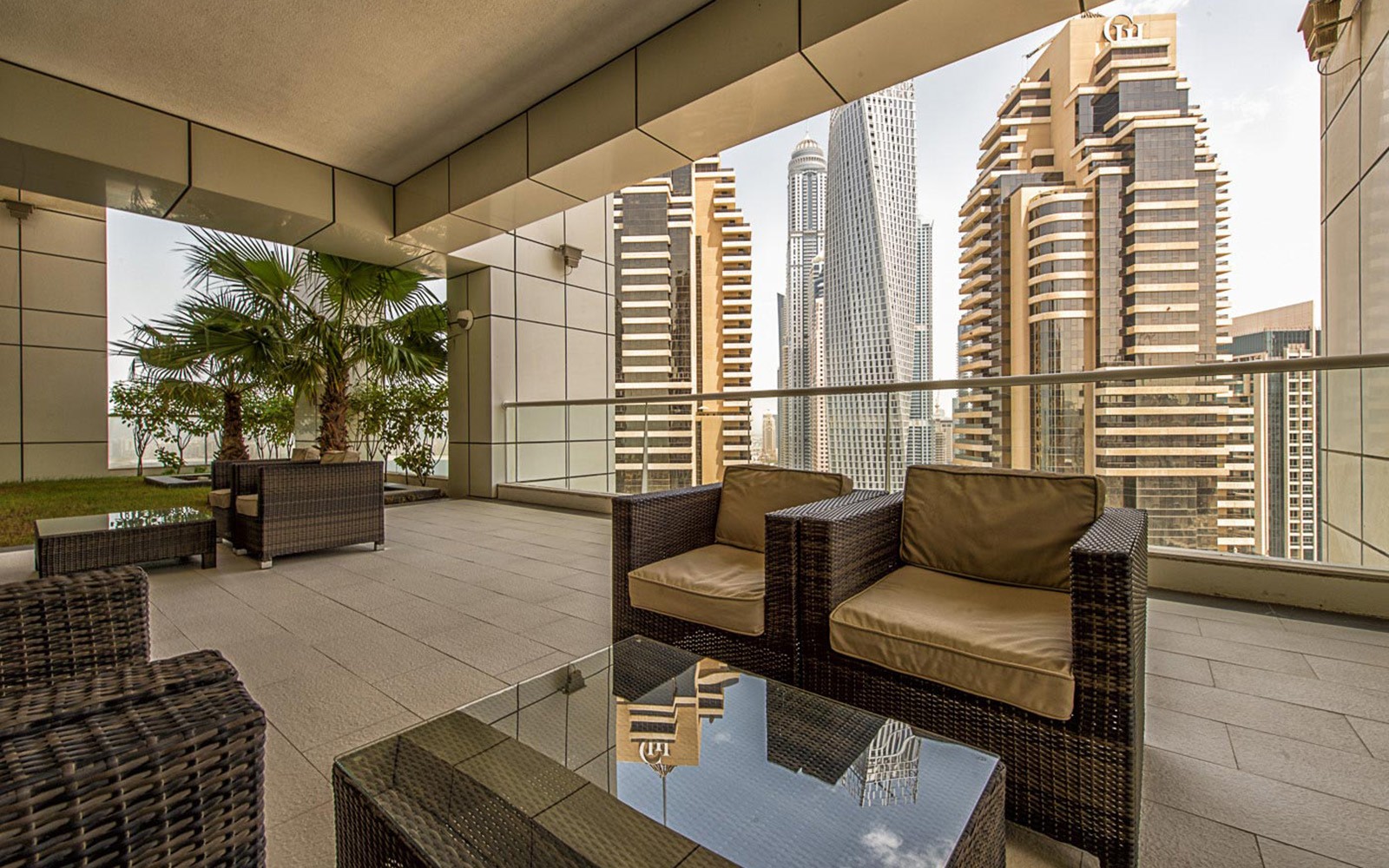 Stylish living room and kitchen in a modern apartment at Botanica Tower, showcasing contemporary design and spaciousness.