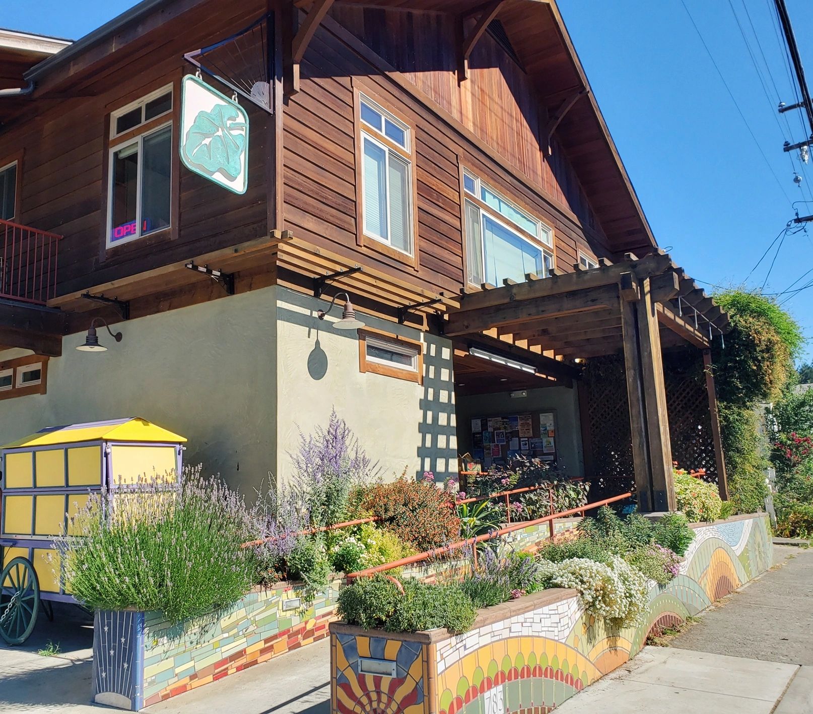 The Chautauqua Natural Foods storefront in Garberville, with a painted planter and garden.