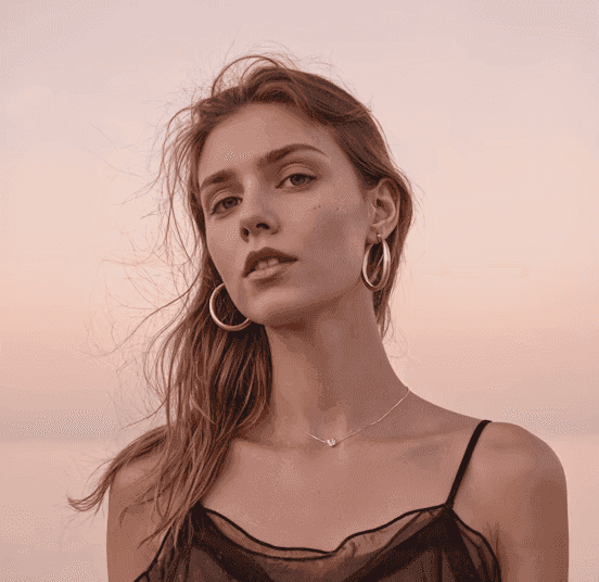 Woman meditating in forest sunlight beside a calm blue lake.