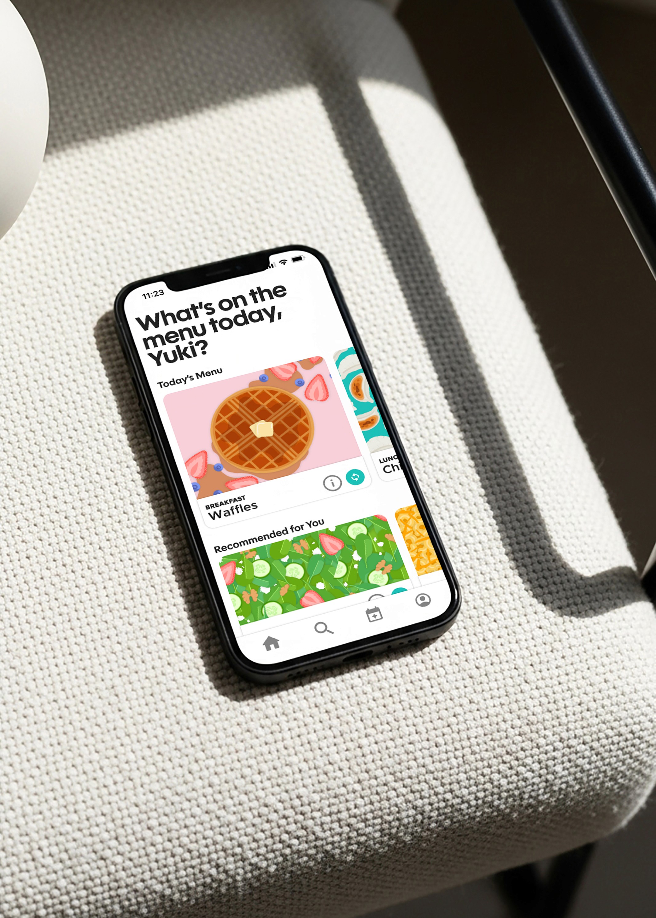 A group of four people engaged in a discussion while seated in a cozy, plant-filled setting.