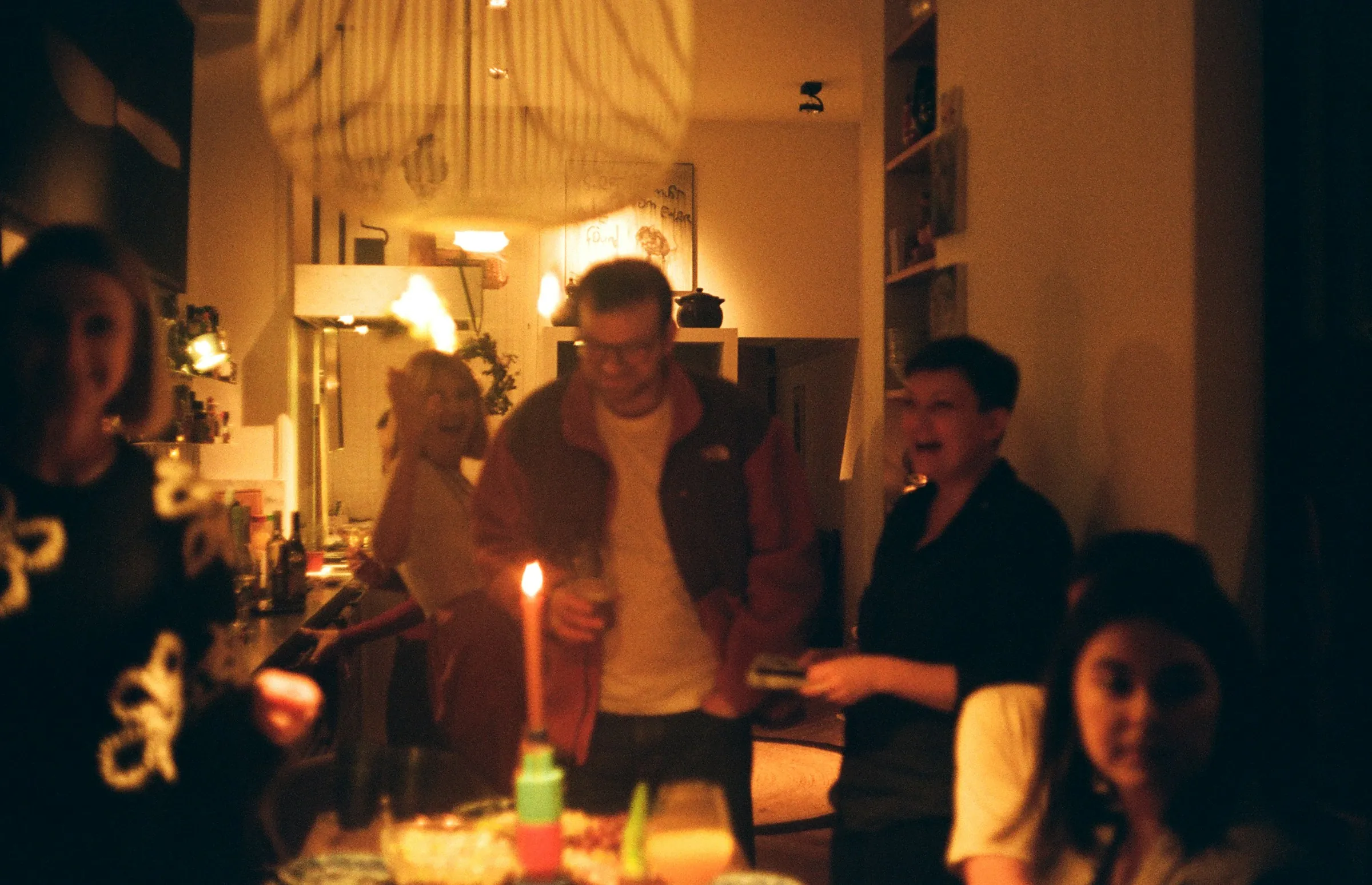 Friends talking around a candlelit dinner table