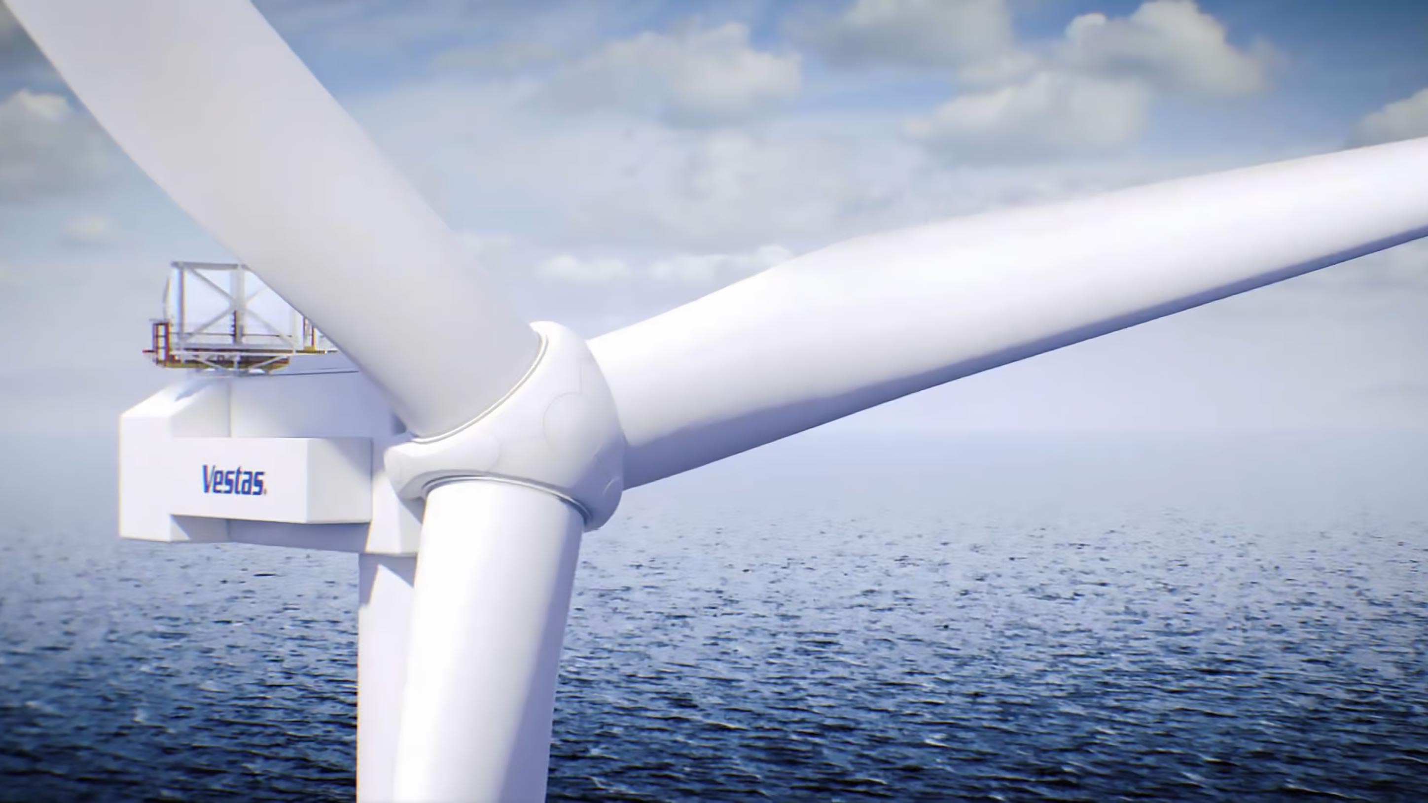 Close-up of an offshore wind turbine nacelle and blades above the sea.