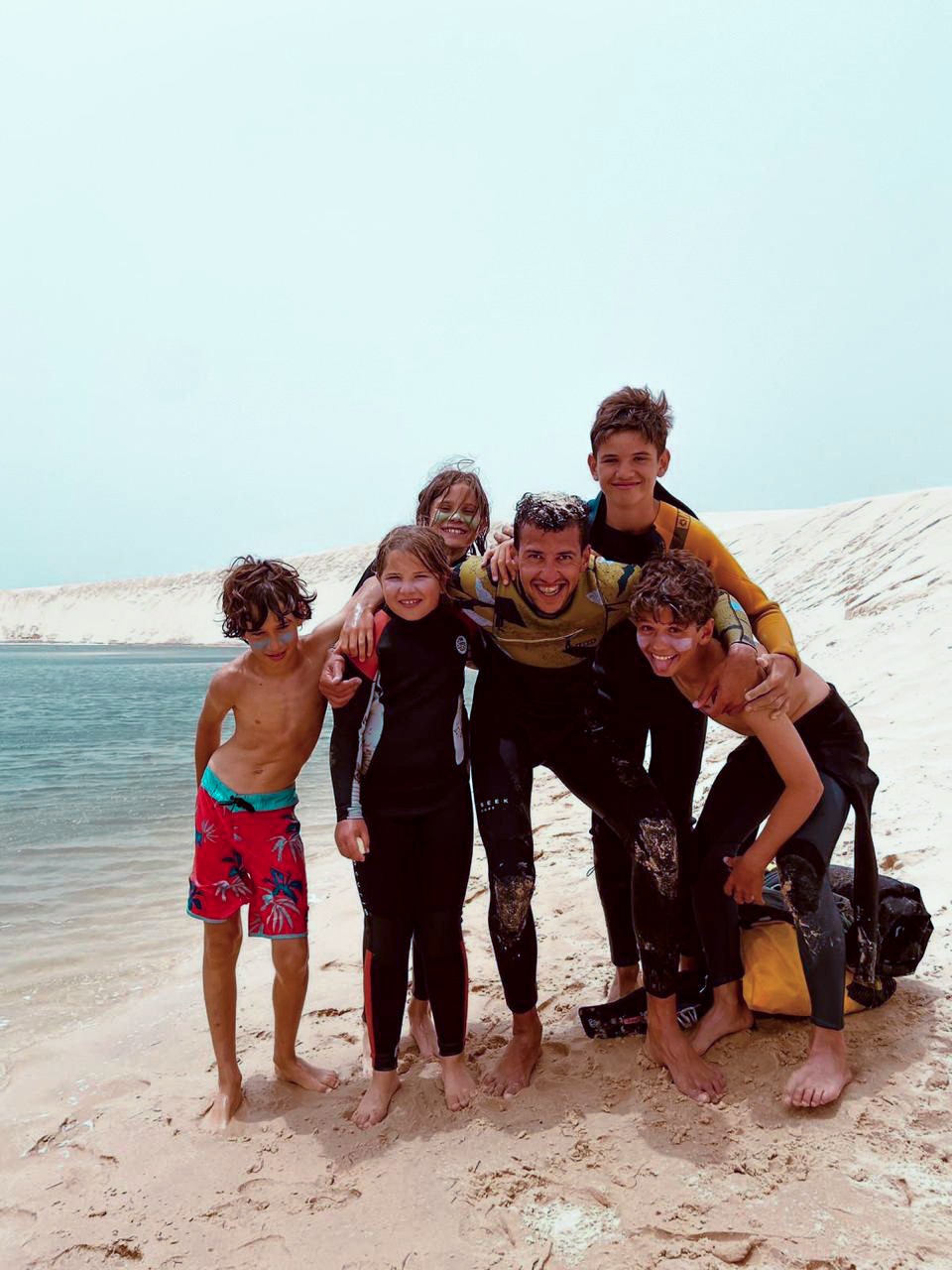 Group of men standing with Sufboard