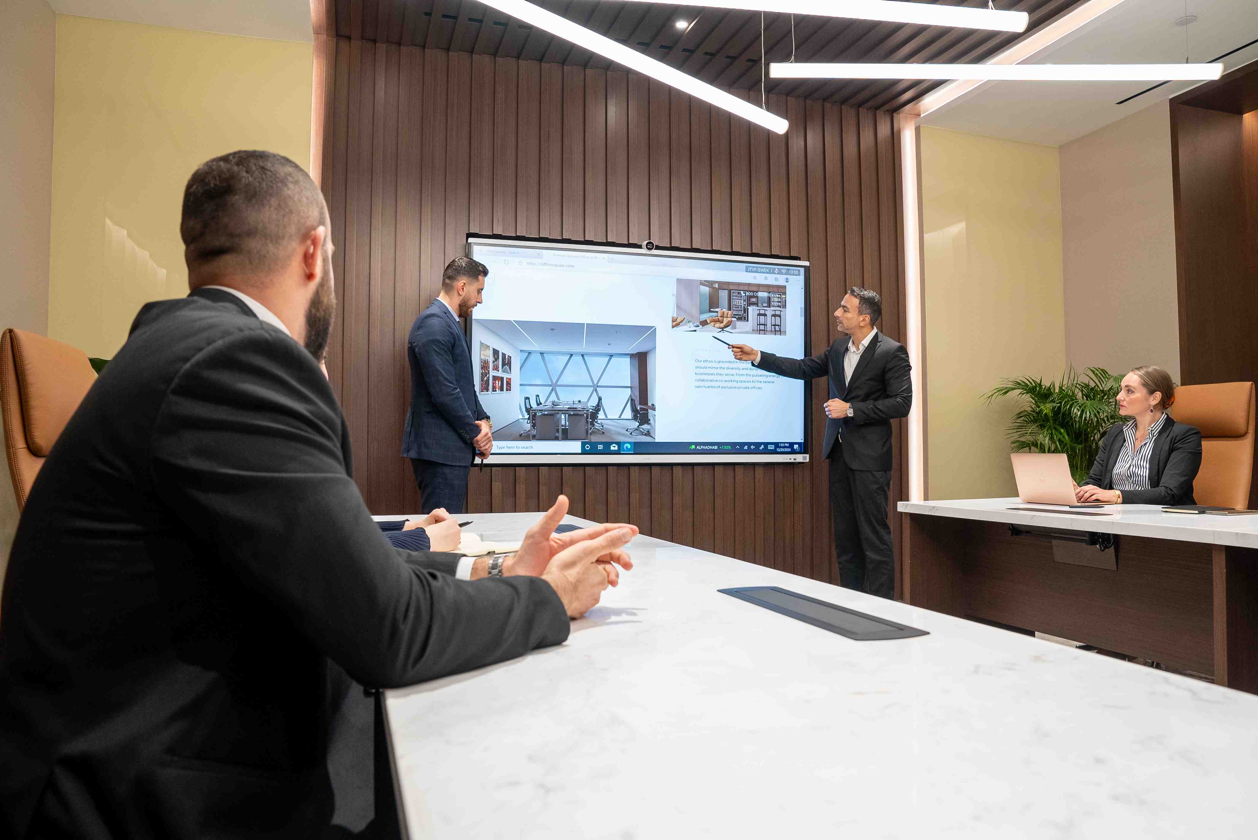 Executives conducting a presentation inside a high-end meeting room in Abu Dhabi