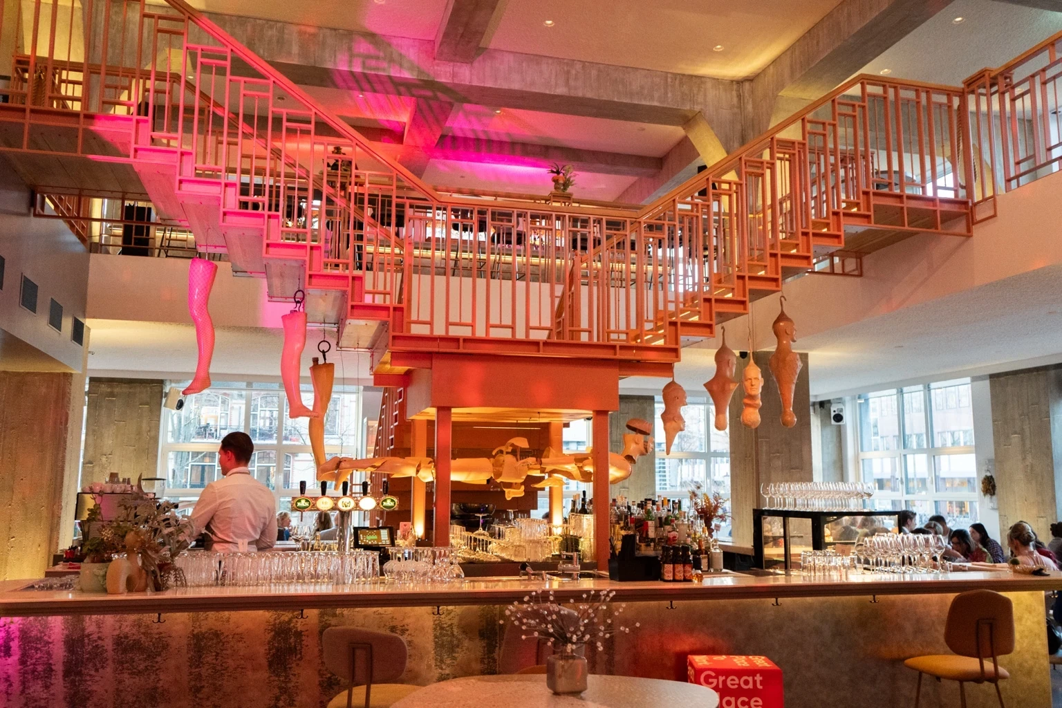 Interior of Capital Kitchen in Amsterdam with its central bar, contemporary art installation and open restaurant space inside Capital C.