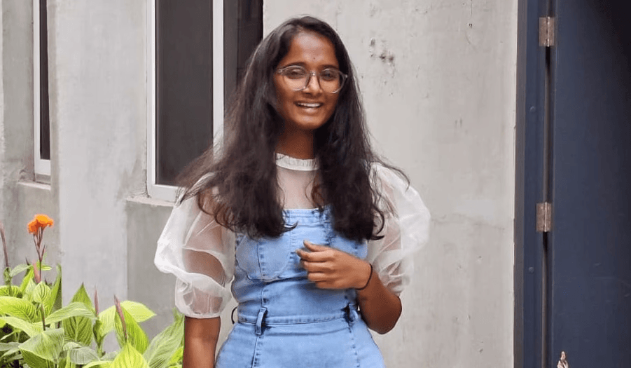 Peace Badejo, wearing sunglasses, looking to the left.